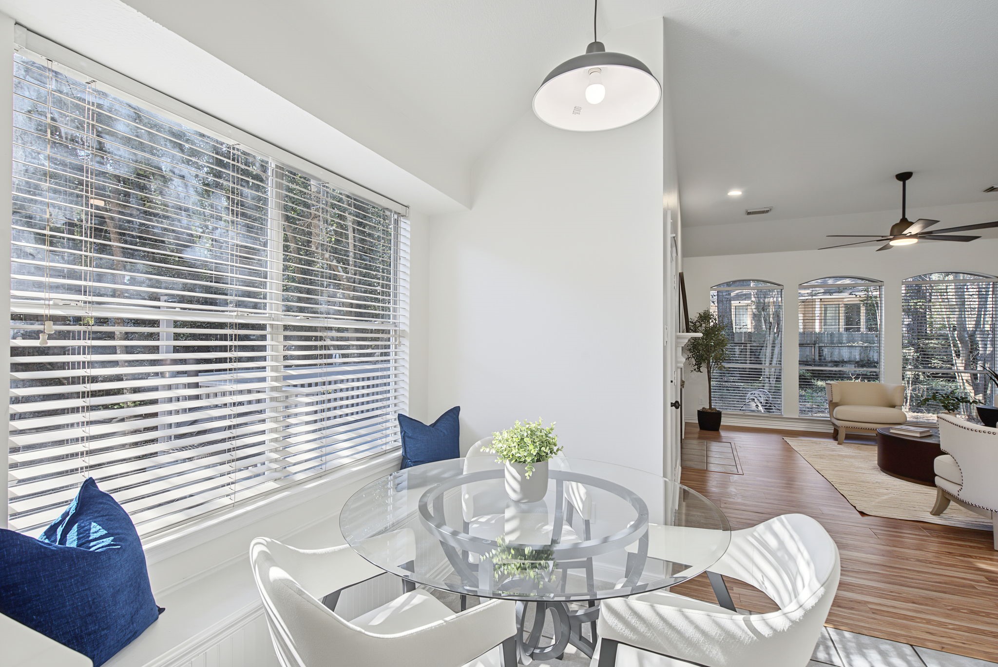 Start the morning beside a broad window in the breakfast nook, complete with a built-in window seat and views toward the living room.