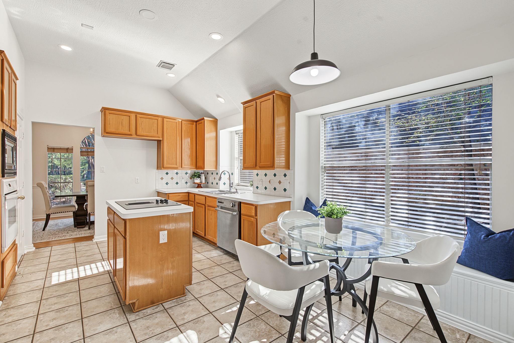 A center island, breakfast nook, and updated lighting provide a starting point for a kitchen you can personalize to your taste.