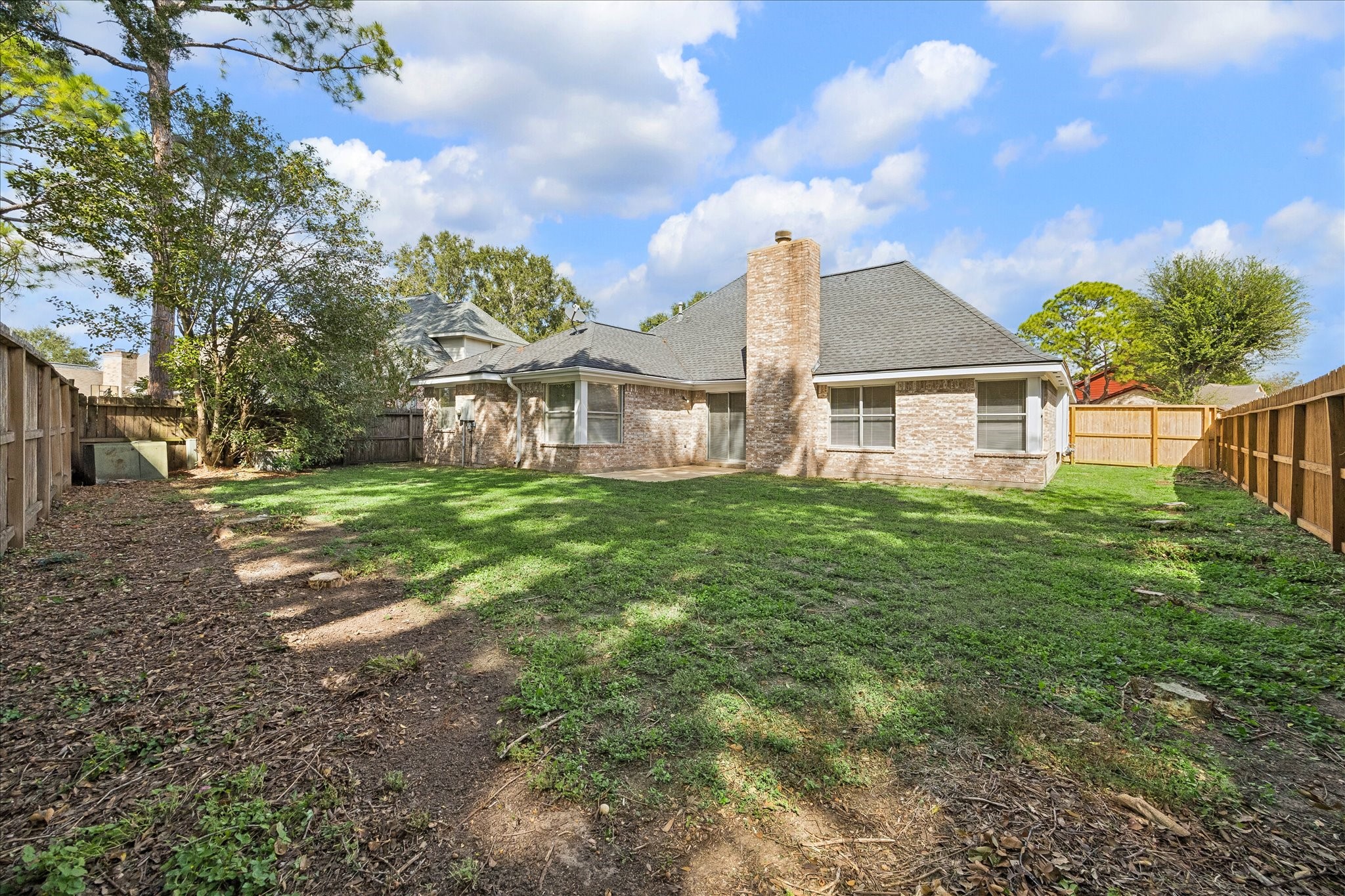 This spacious backyard offers endless possibilities for entertaining