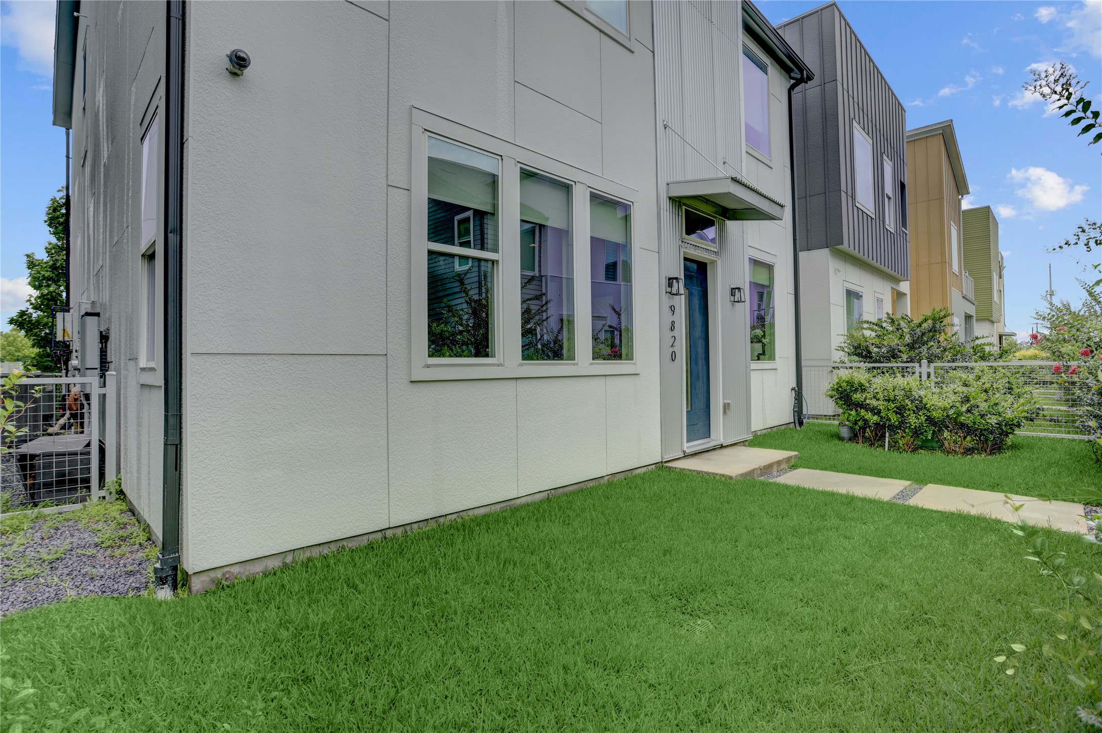 Standing in your yard, you see your modern sleek exterior with large windows and a well-maintained front lawn, offering contemporary style and curb appeal. Standing in your yard, you see your modern sleek exterior with large windows and a well-maintained front lawn, offering contemporary style and curb appeal.