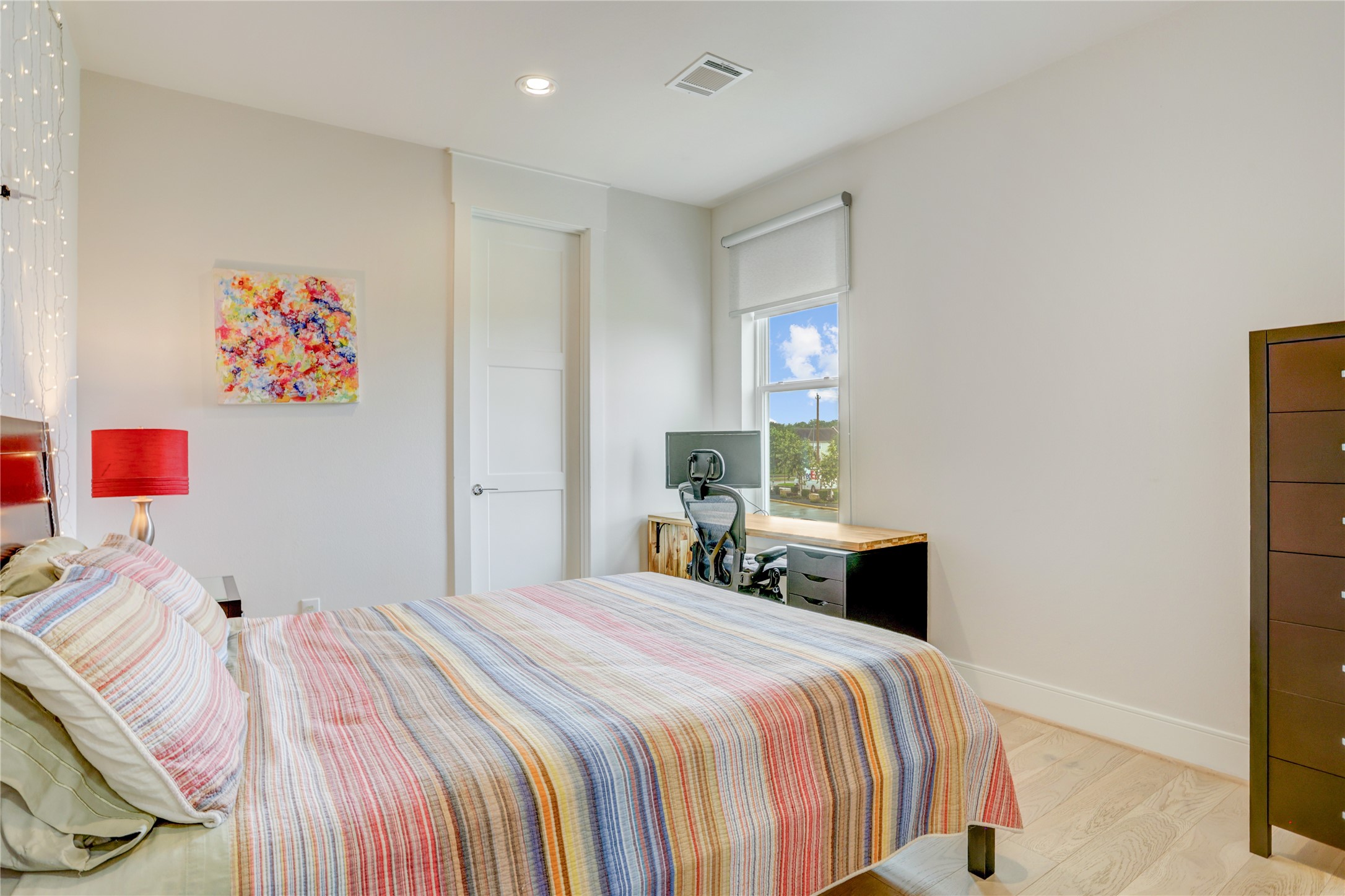 Bright and inviting guest bedroom featuring a cozy, with a window view.