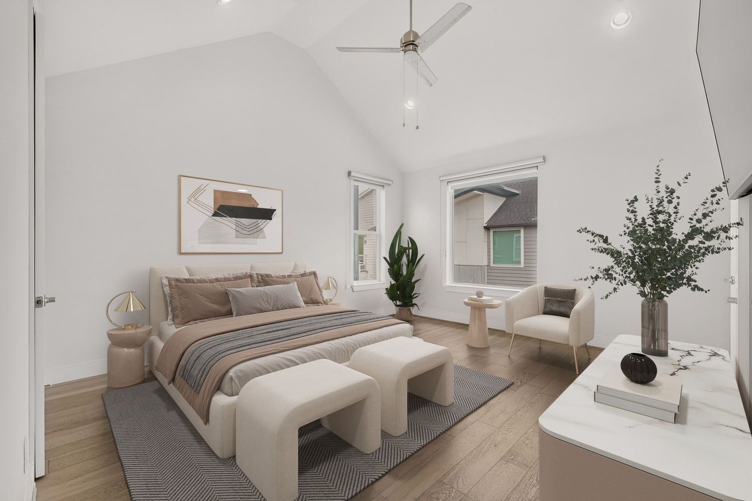 Spacious Primary bedroom with vaulted ceilings, modern decor, and abundant natural light from large windows, offering a serene retreat.