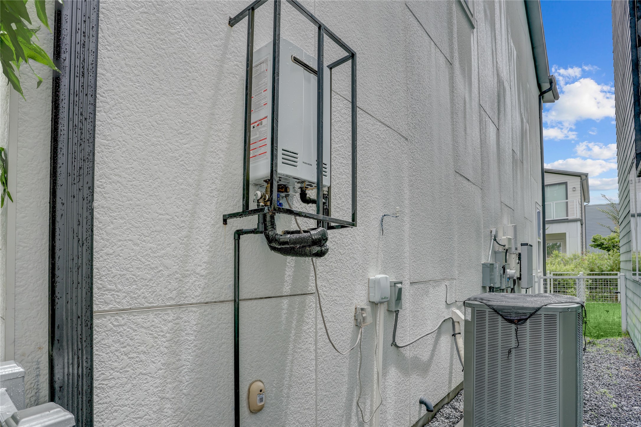 Modern exterior with a tankless water heater and efficient HVAC system, enhancing energy savings and comfort.