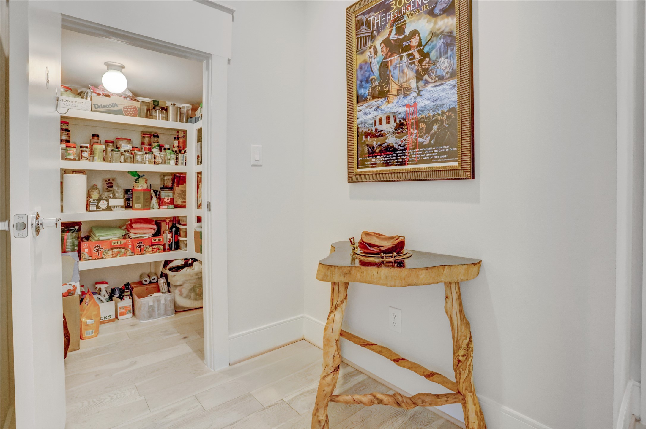 A neatly organized pantry with ample shelving provides convenient storage, while the adjacent hallway adding charm to the space.