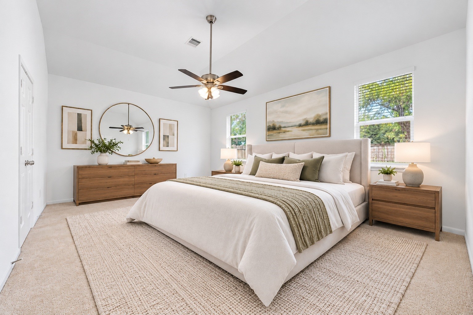 Retreat to the spacious primary bedroom, where a vaulted ceiling, a ceiling fan with light, and plush carpet create a restful space. Two windows dressed in new blinds frame views of mature trees. Virtually staged. Retreat to the spacious primary bedroom, where a vaulted ceiling, a ceiling fan with light, and plush carpet create a restful space. Two windows dressed in new blinds frame views of mature trees. Virtually staged.