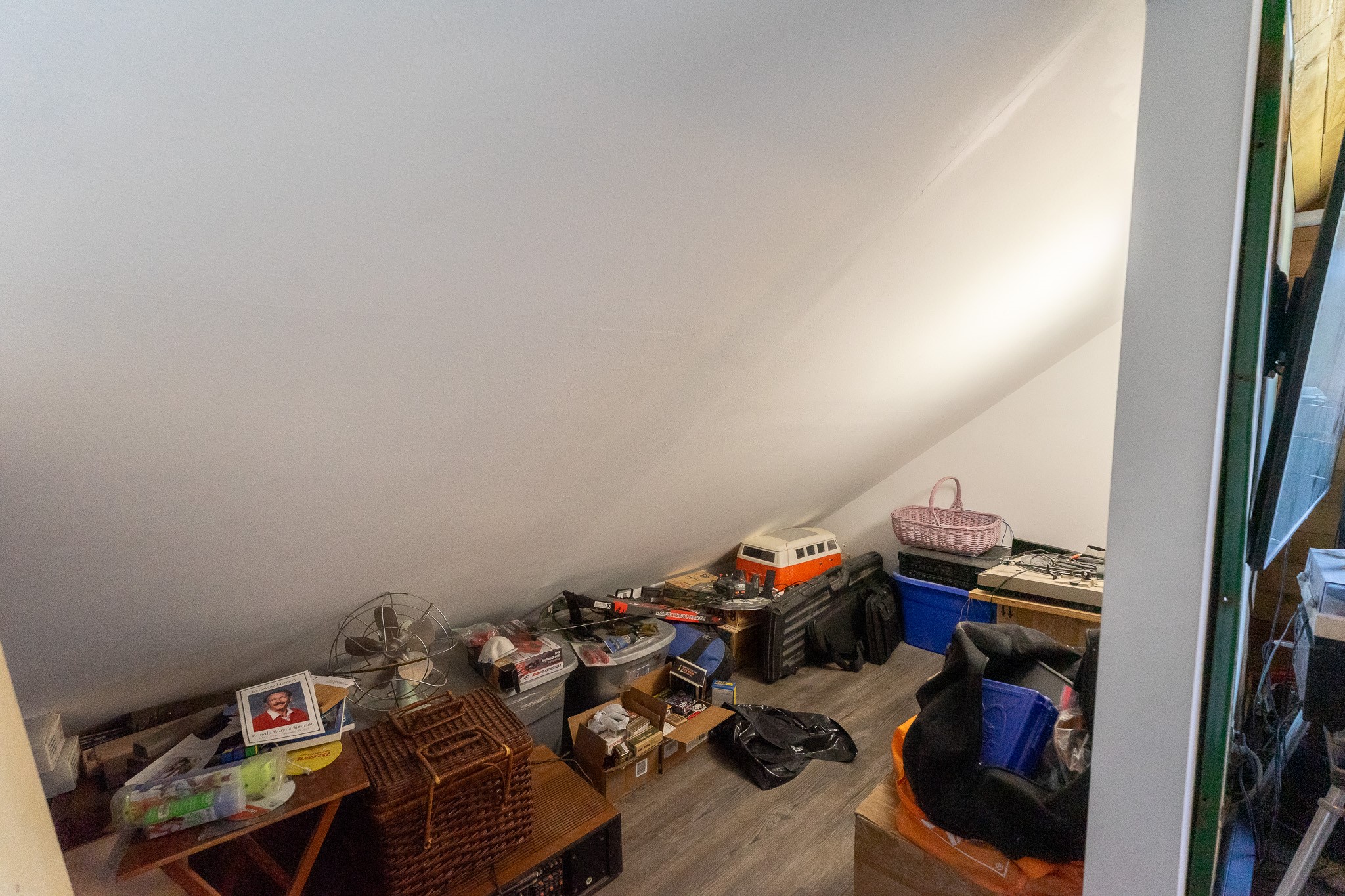 This storage area is off the upstairs bedroom.  The ceiling is sloped... duck!  Great storage space, just be careful moving around in there!
