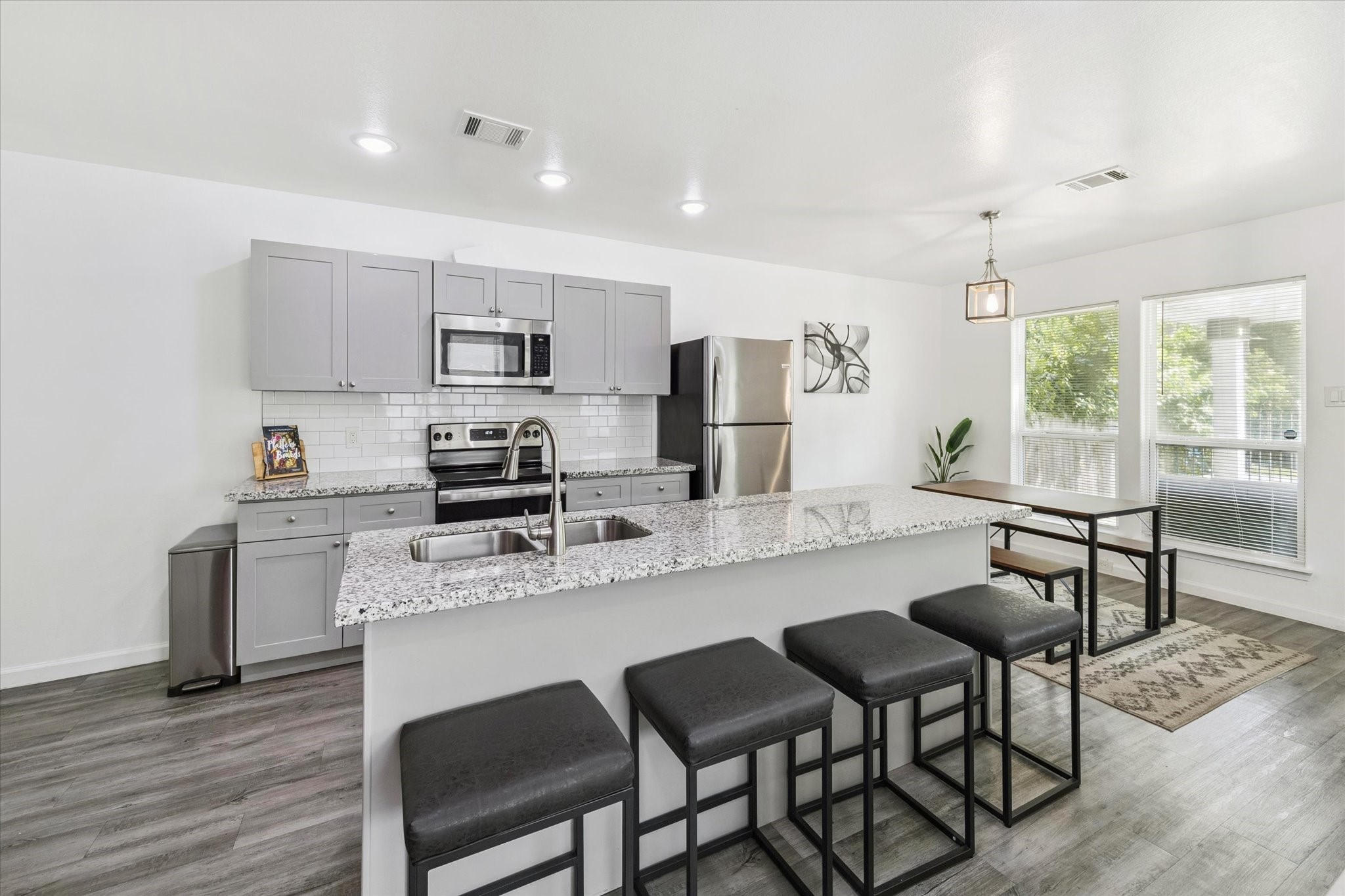 The front entry welcomes you with abundant natural light from oversized windows and a clean, open feel. Modern flooring and a sleek light fixture set the tone for the homes style