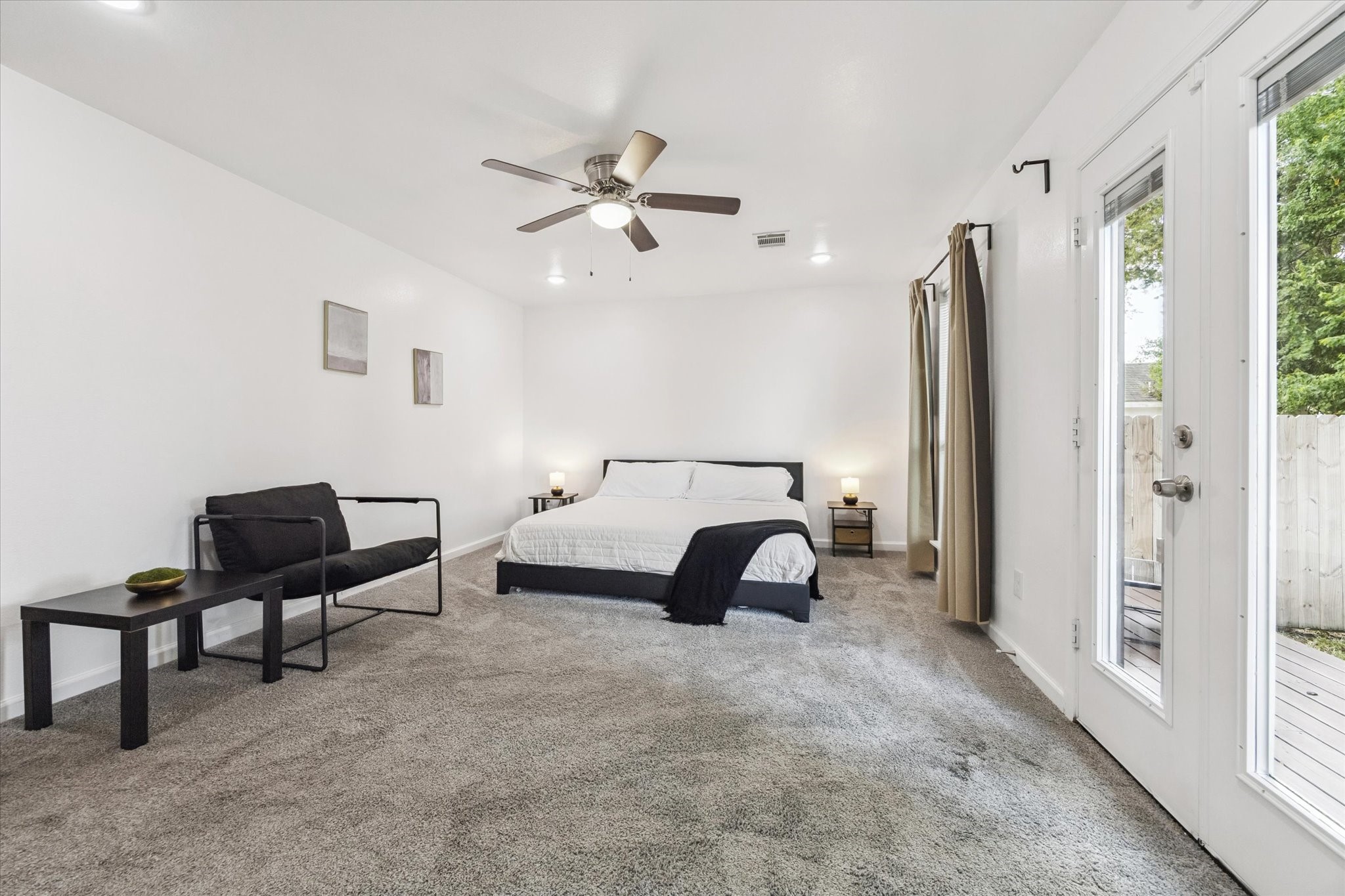 The primary bedroom is generously sized with plenty of room to stretch out. It features recessed lighting, a ceiling fan with light kit, and direct access to a large outdoor deckideal for morning coffee or winding down in the evening.