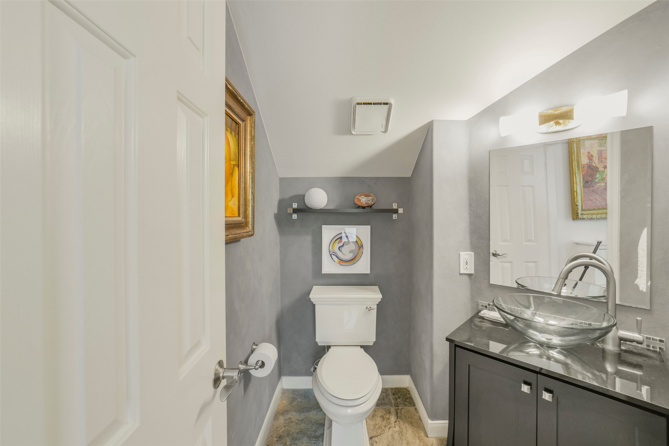 Half bathroom on the second level, tucked away from the kitchen