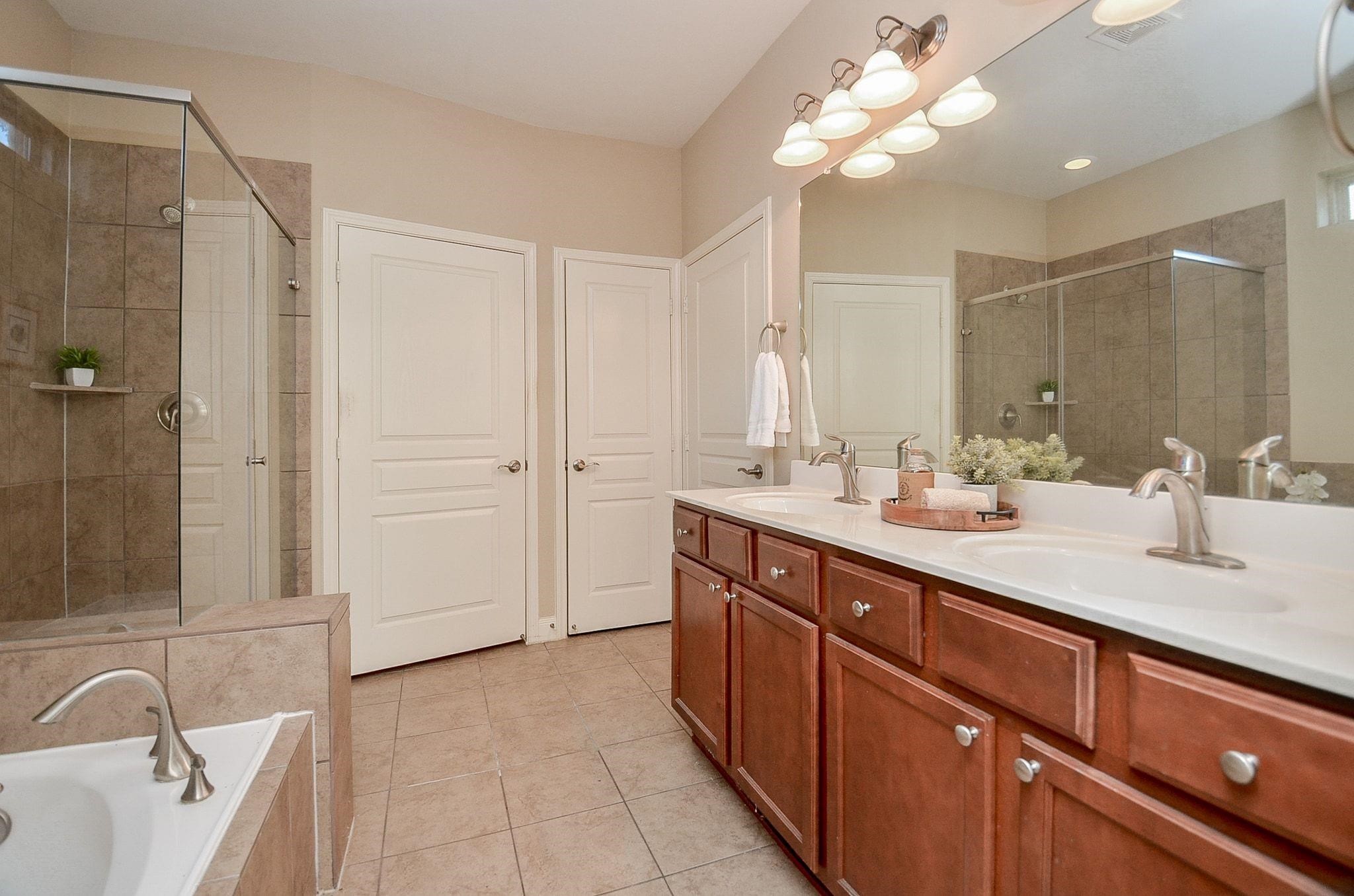 Large Bathroom Ensuite with Oversized double vanity, soaking tub, and Large Shower