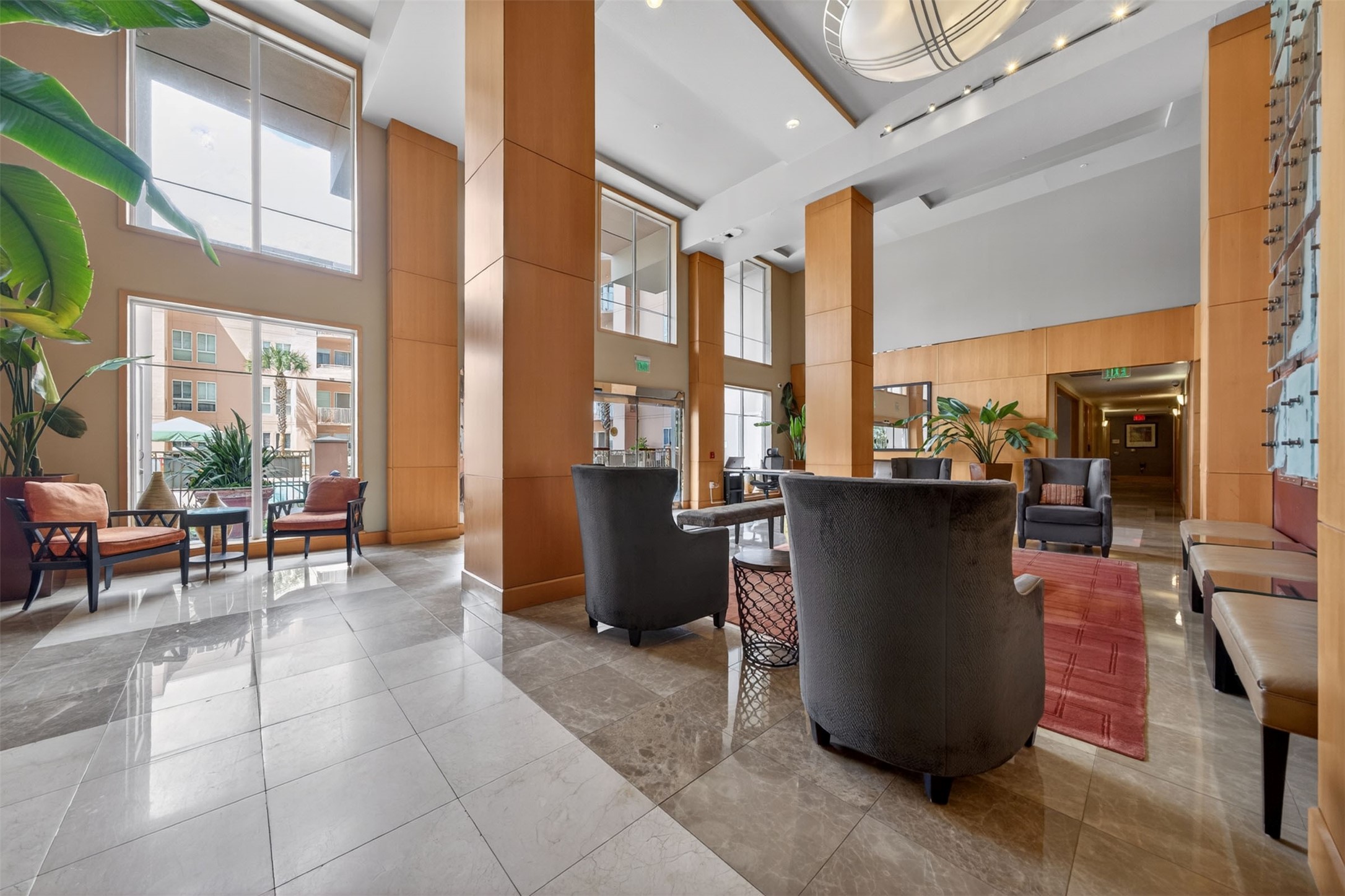 Elegant lobby with high ceilings, abundant natural light, and stylish seating areas perfect for relaxation and socializing.