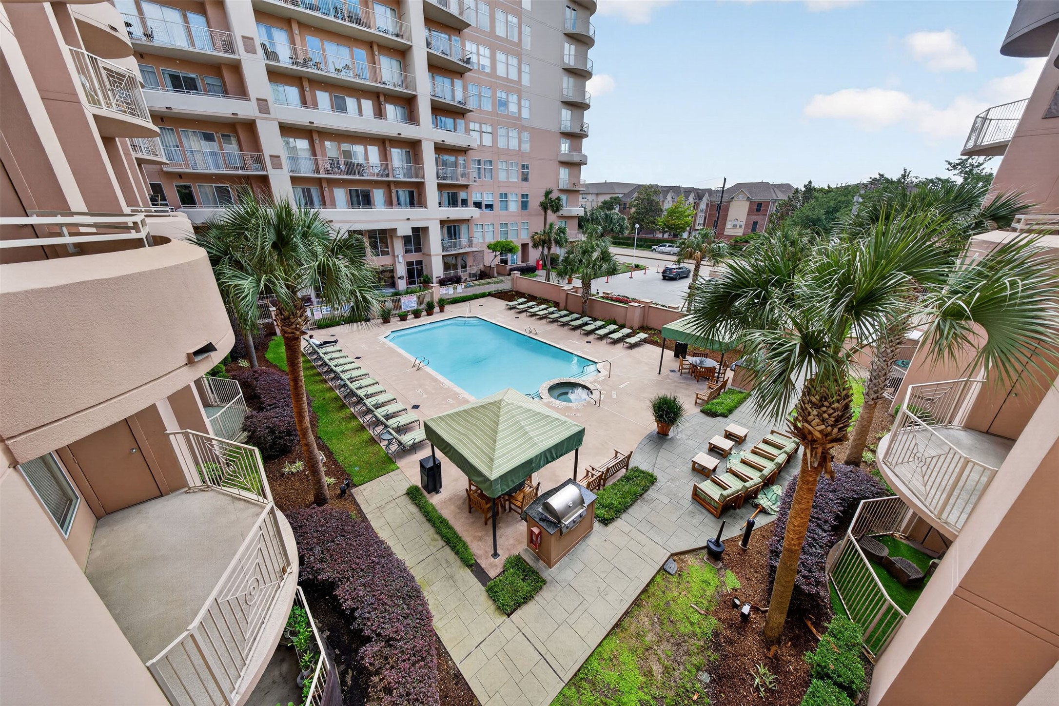 Enjoy resort-style living with a spacious pool, hot tub, and multiple lounging areas surrounded by lush landscaping in this luxurious condominium complex. Enjoy resort-style living with a spacious pool, hot tub, and multiple lounging areas surrounded by lush landscaping in this luxurious condominium complex.