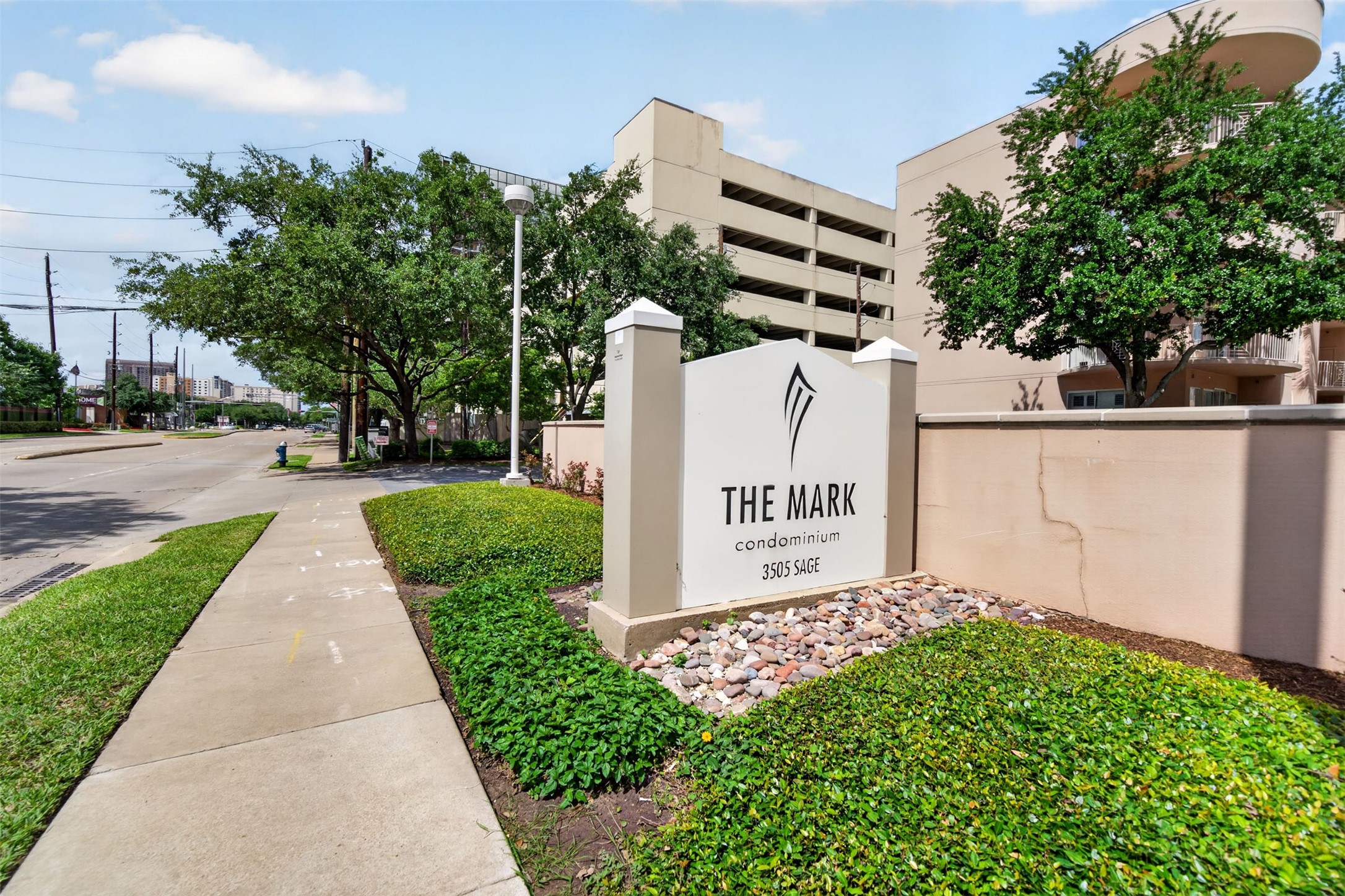 Discover urban living at The Mark Condominium, featuring modern amenities and lush landscaping in a vibrant neighborhood.