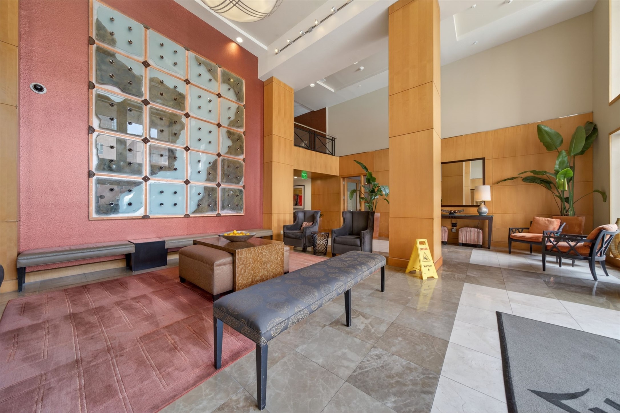 Spacious and elegant lobby featuring modern art, comfortable seating, and abundant natural light, creating a welcoming atmosphere.