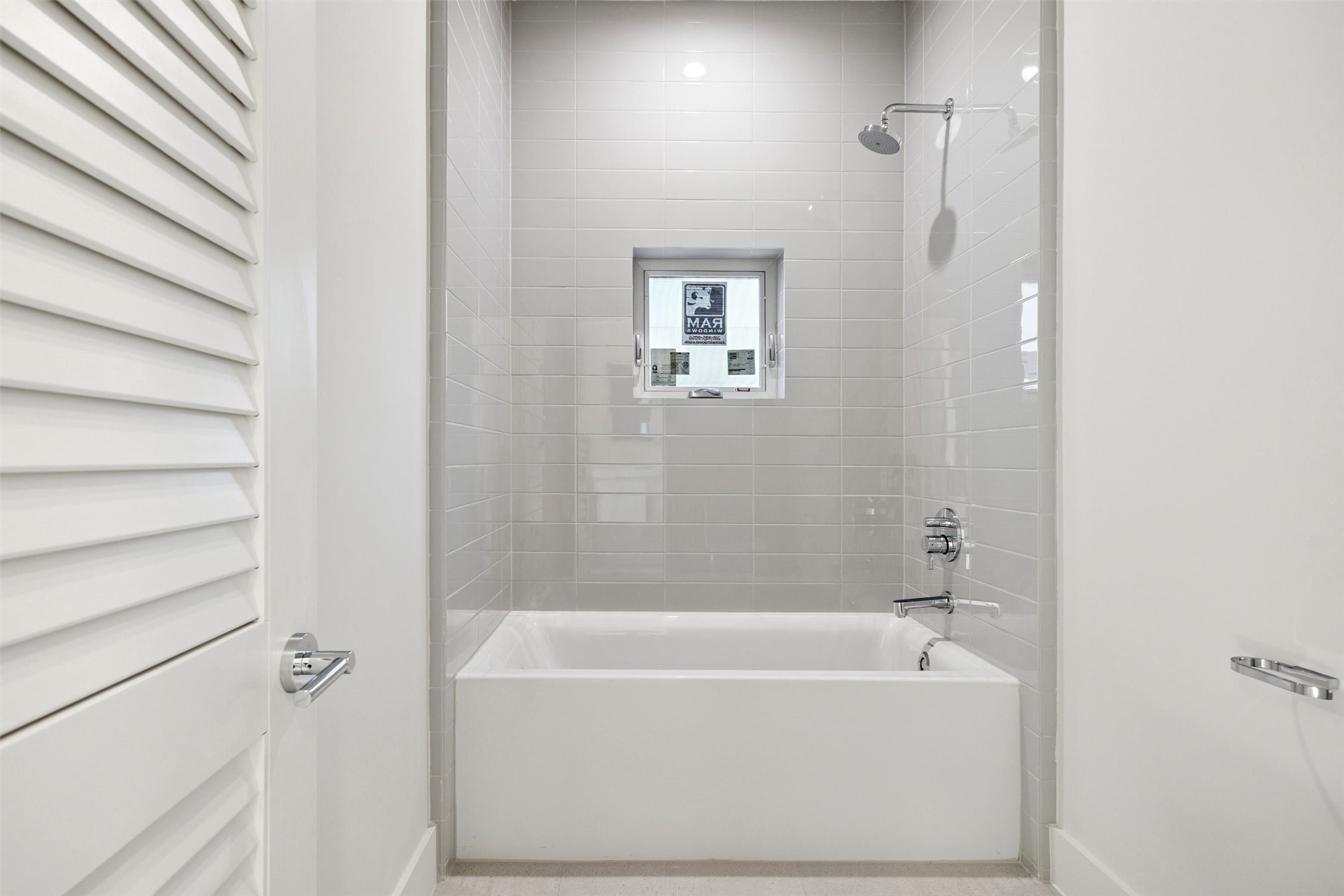 The tub/shower combo is tucked away in its own private room.