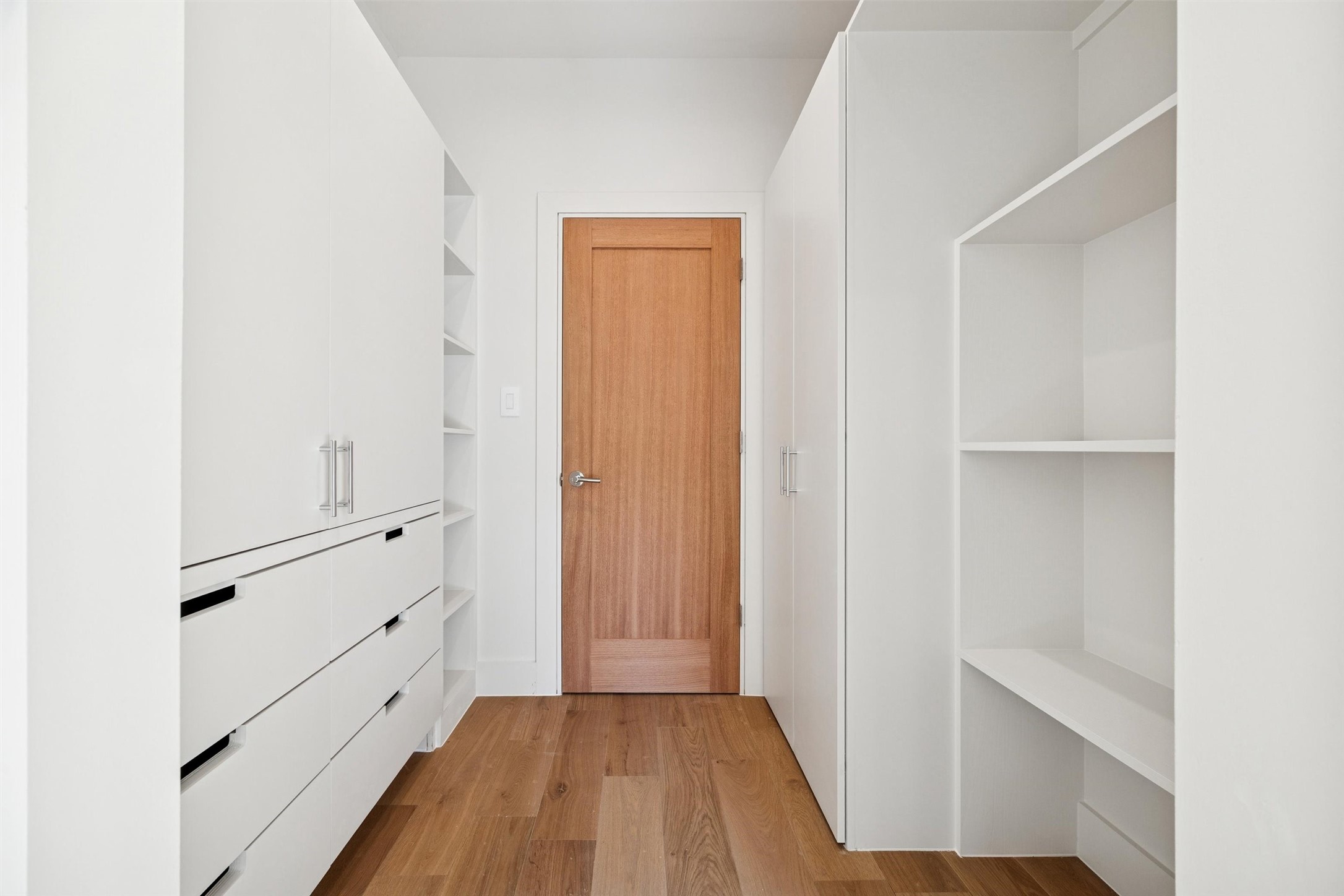 Primary bedroom foyer with closet built-ins for functionality.