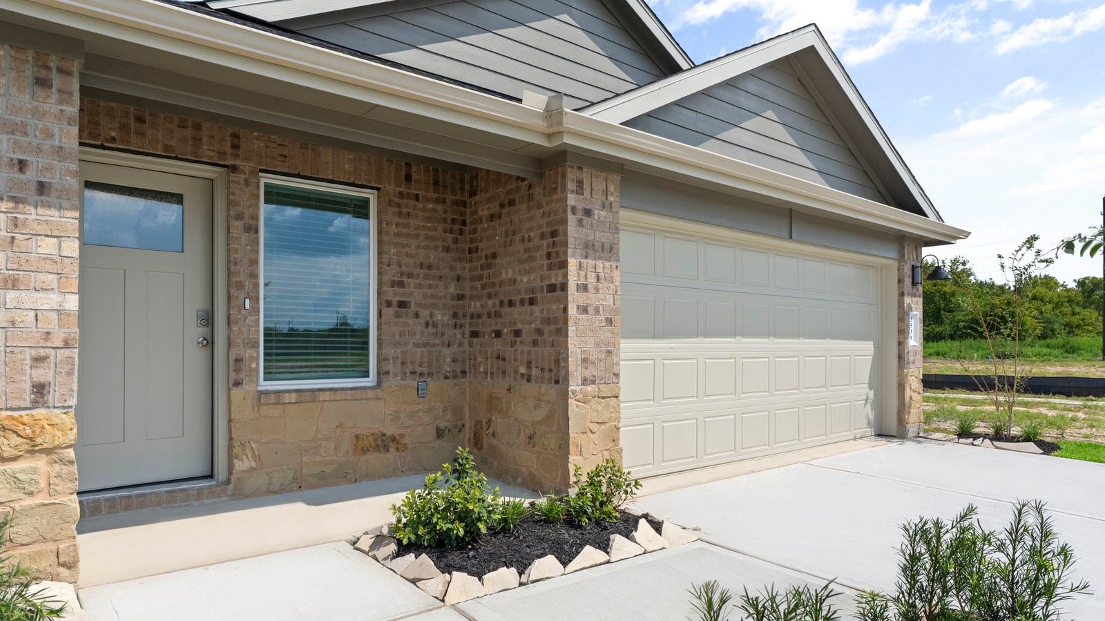 View of the front door and garage