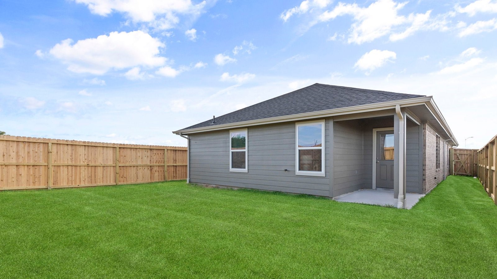 Outdoor covered patio with room for outdoor furniture to enjoy the backyard in those cooler months