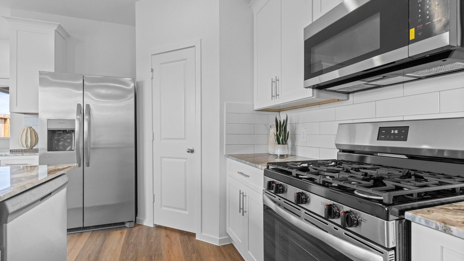 Kitchen adorned with painted cabinets seamlessly integrated into an open dining area layout.