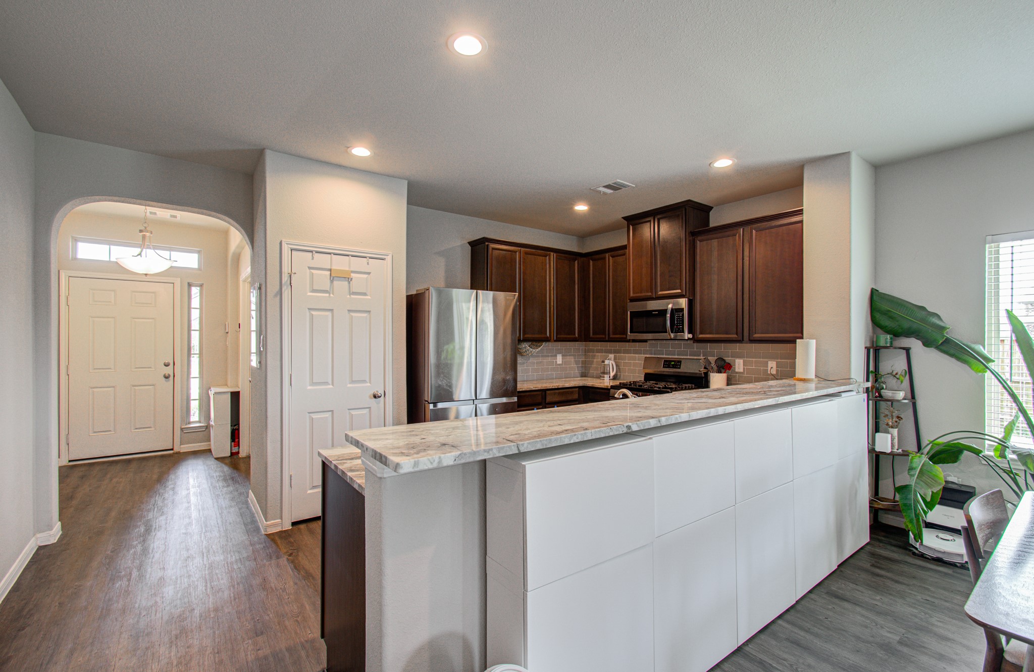 Kitchen bar for more space to dine and entertain (white storage cabinets underneath the bar will be removed).