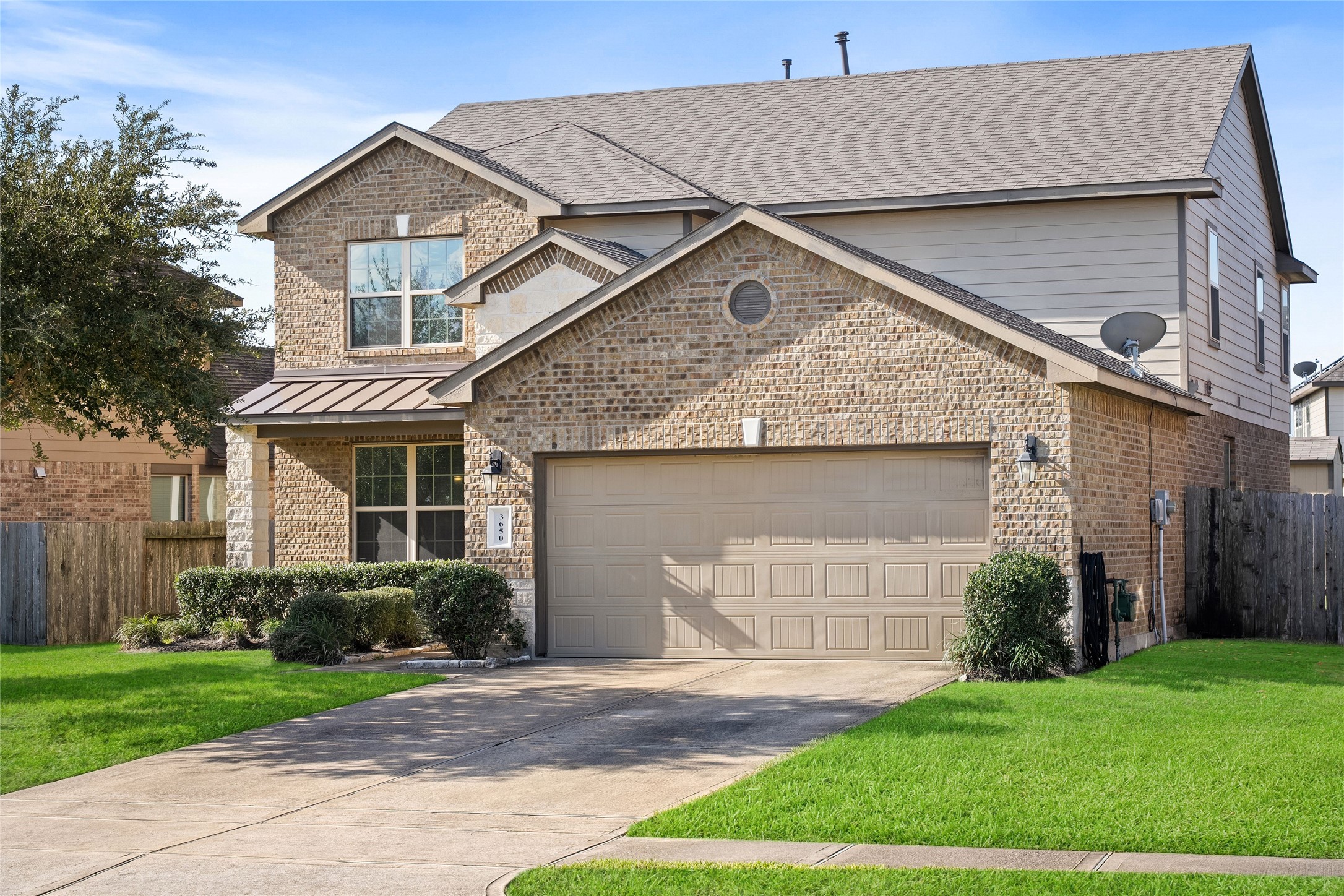 Charming two-story brick home with a spacious two-car garage and well-maintained landscaping, offering great curb appeal in a quiet neighborhood.