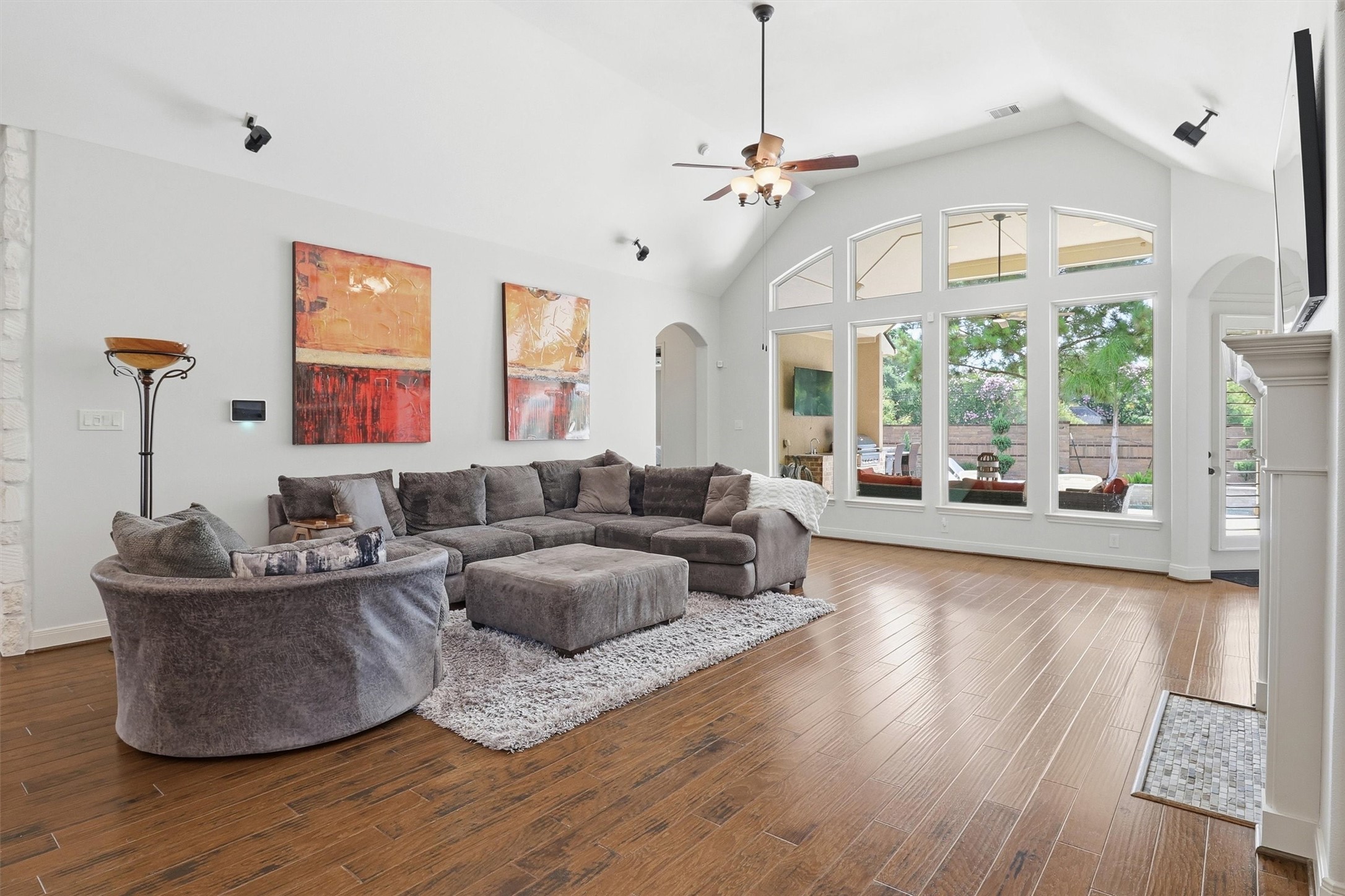 Huge windows bathe the room in light while a vaulted ceilings gives this large living area a lofty, airy feel.