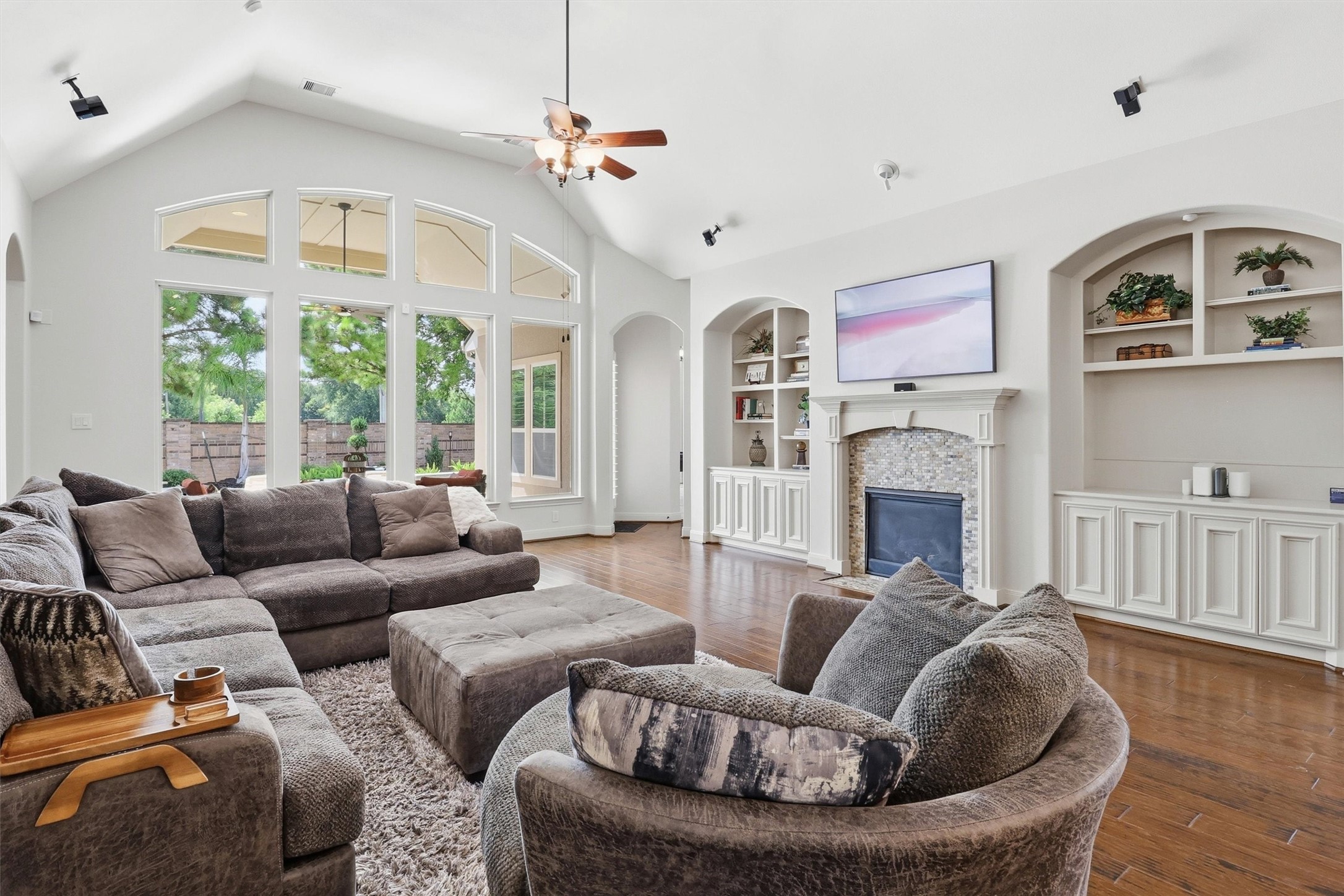 What a gorgeous, open space this is with a tiled fireplace with a classic mantle and double-ended built in's on either side, providing both beauty and storage.