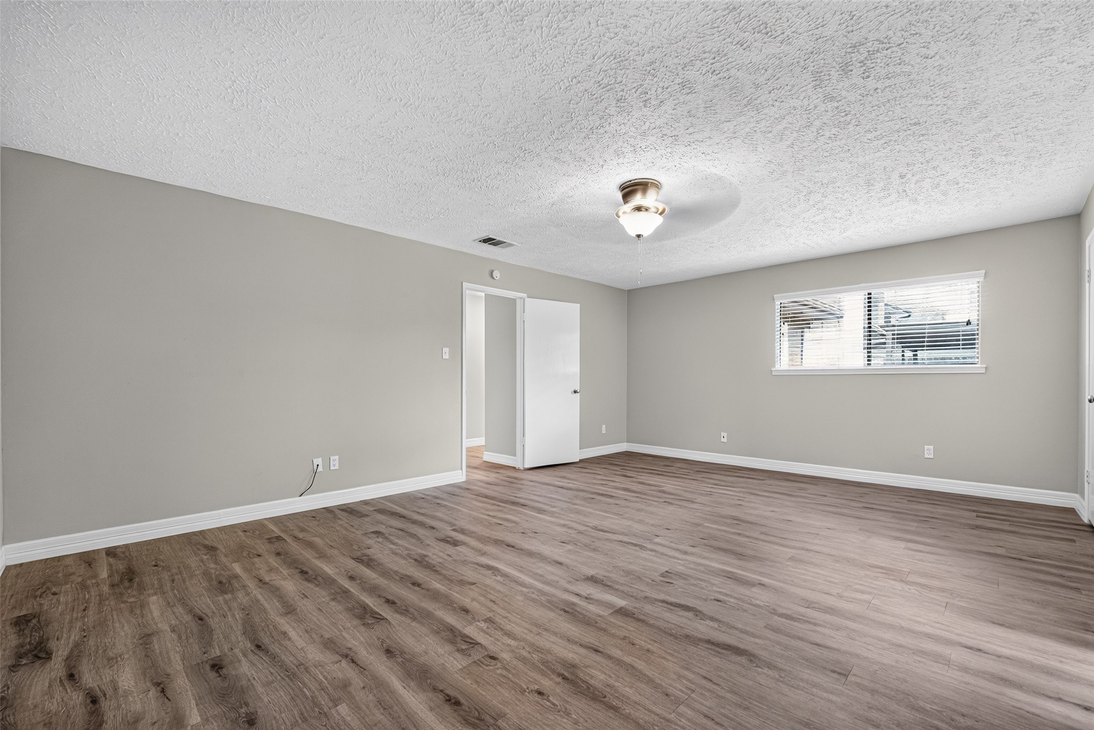 Primary bedroom is large enough for king bed and sitting area