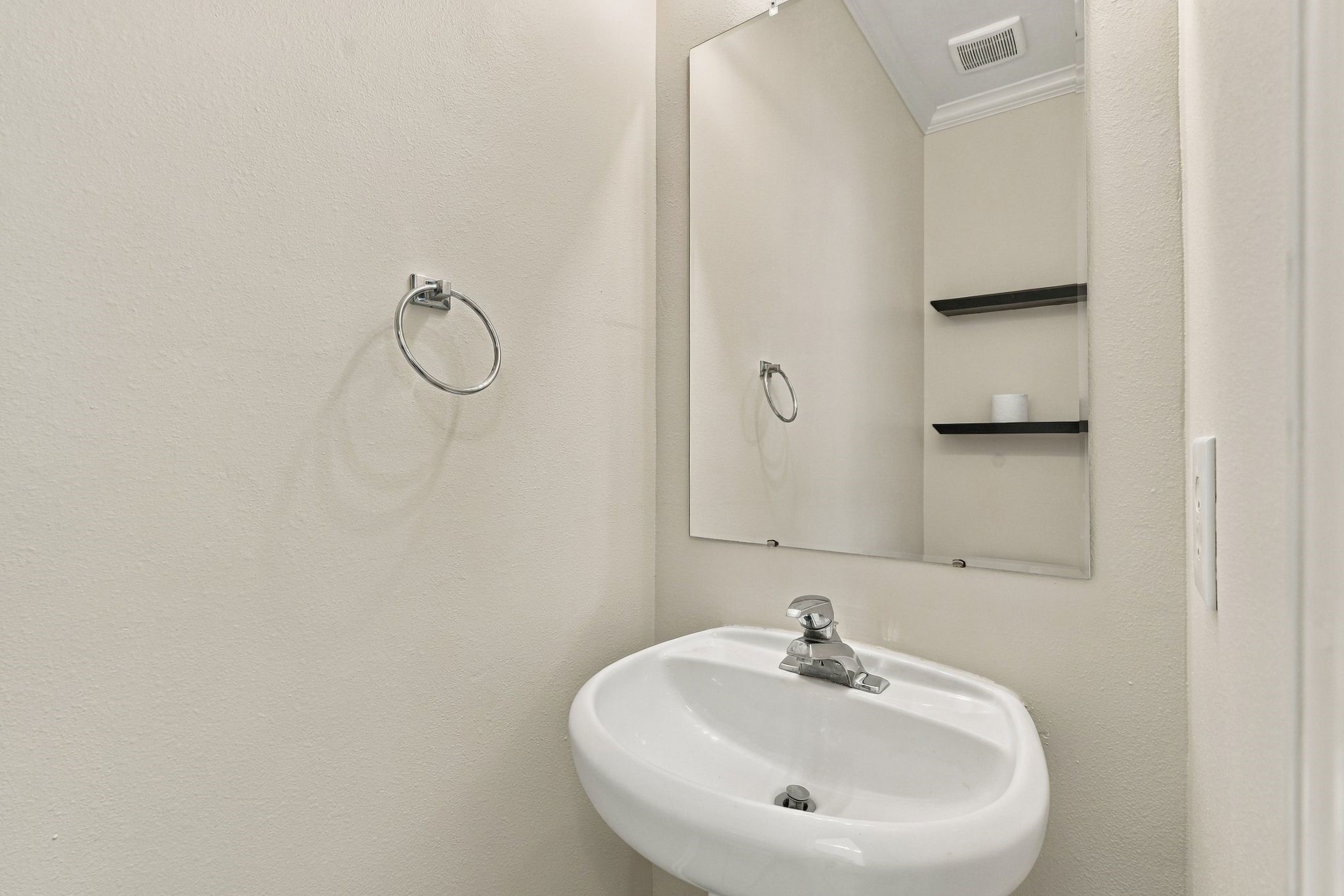 This first floor half bath is behind the door next to the stairs.