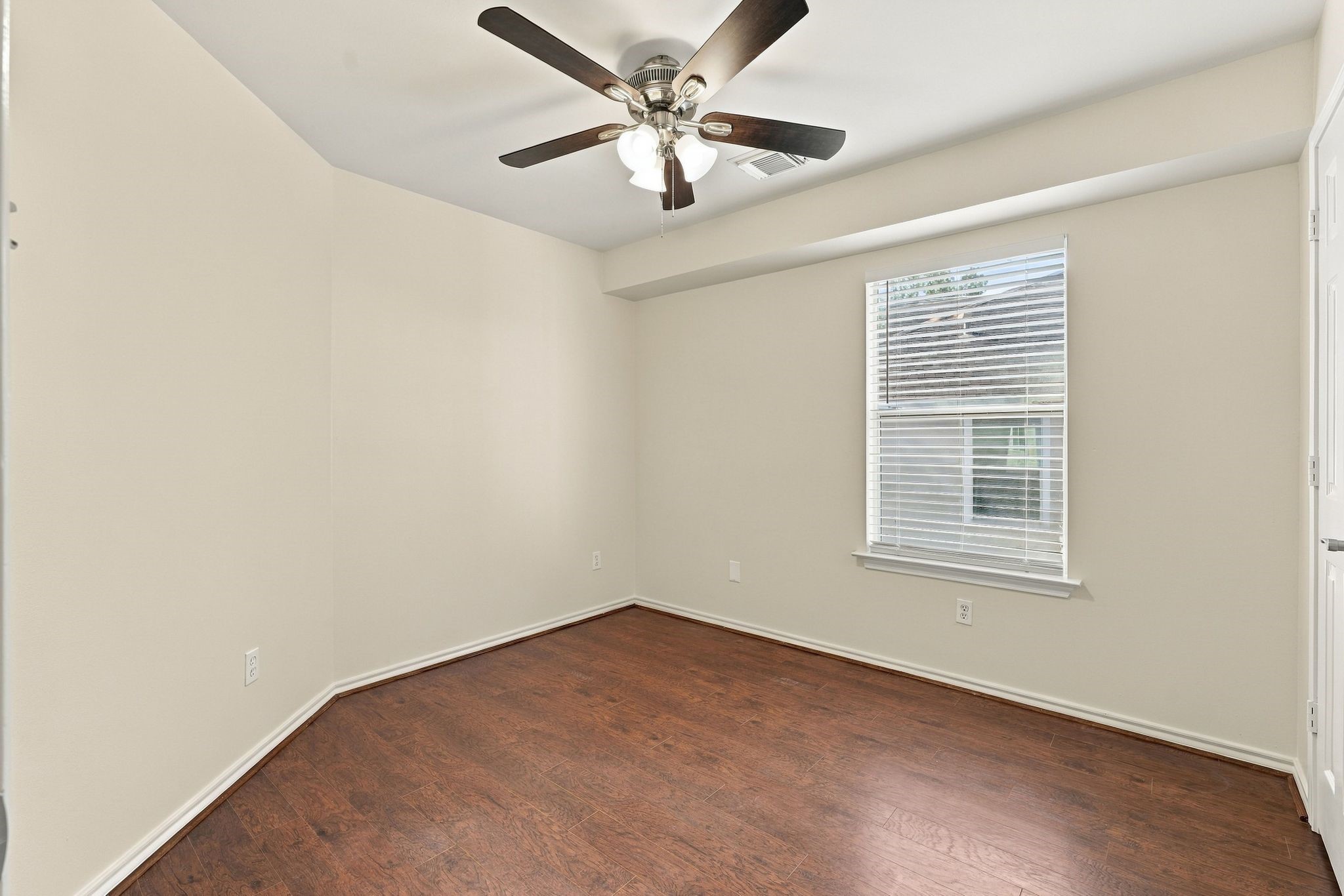 Bedroom number 2 has the wood look flooring, new paint and new ceiling fan.