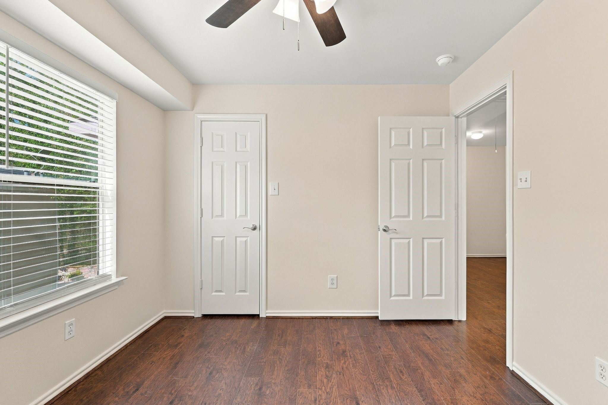 Bedroom number 2 has the wood look flooring, new paint and new ceiling fan.