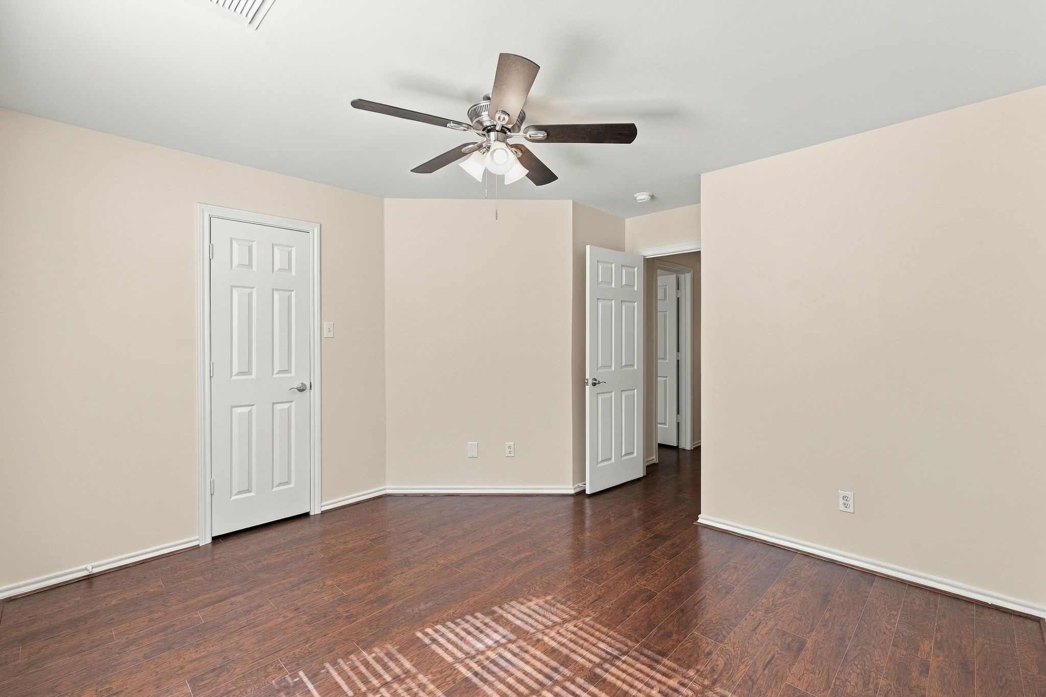 Bedroom number 3 has wood look flooring, new paint and new ceiling fan.