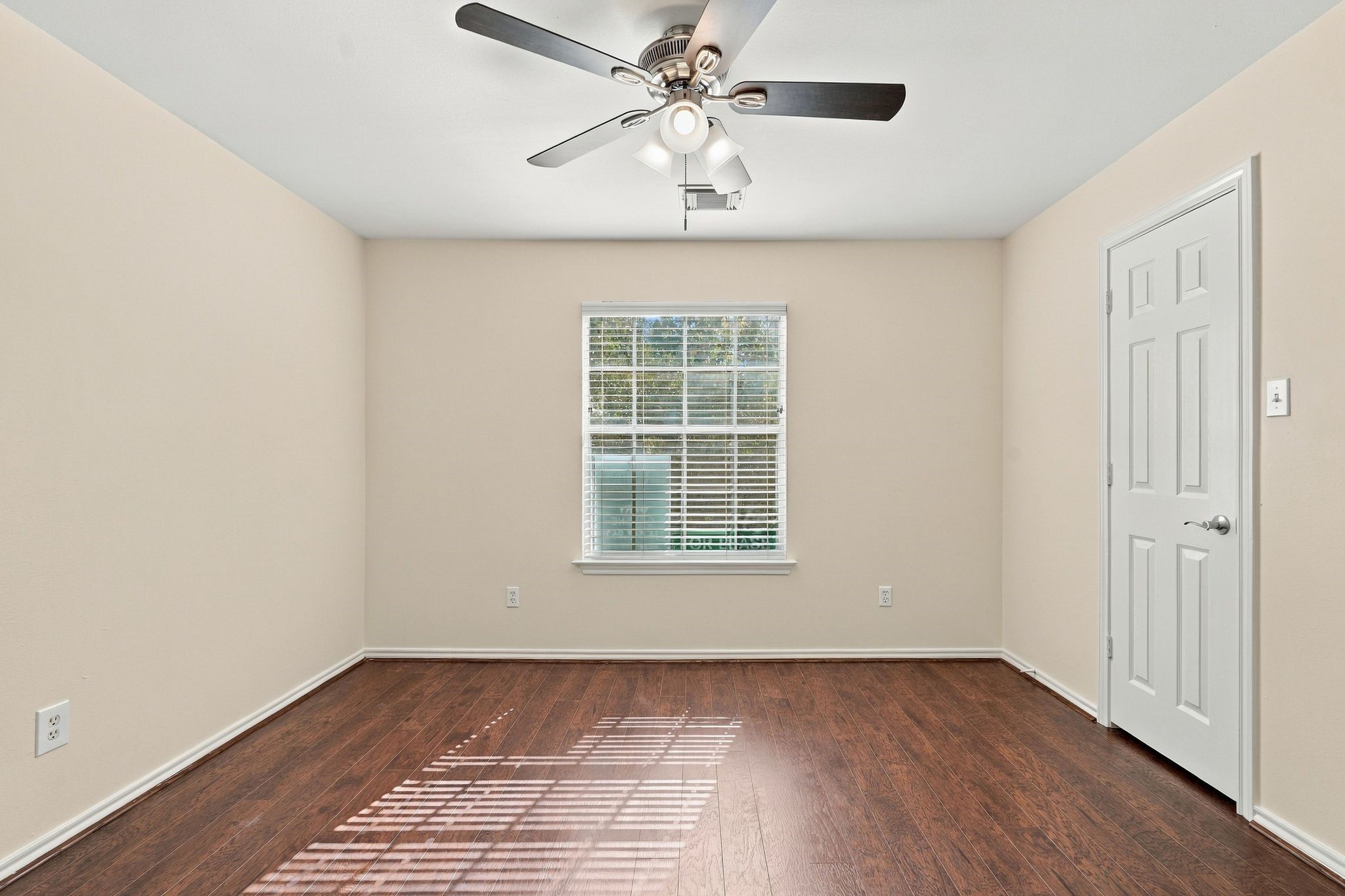 Bedroom number 3 has wood look flooring, new paint and new ceiling fan.