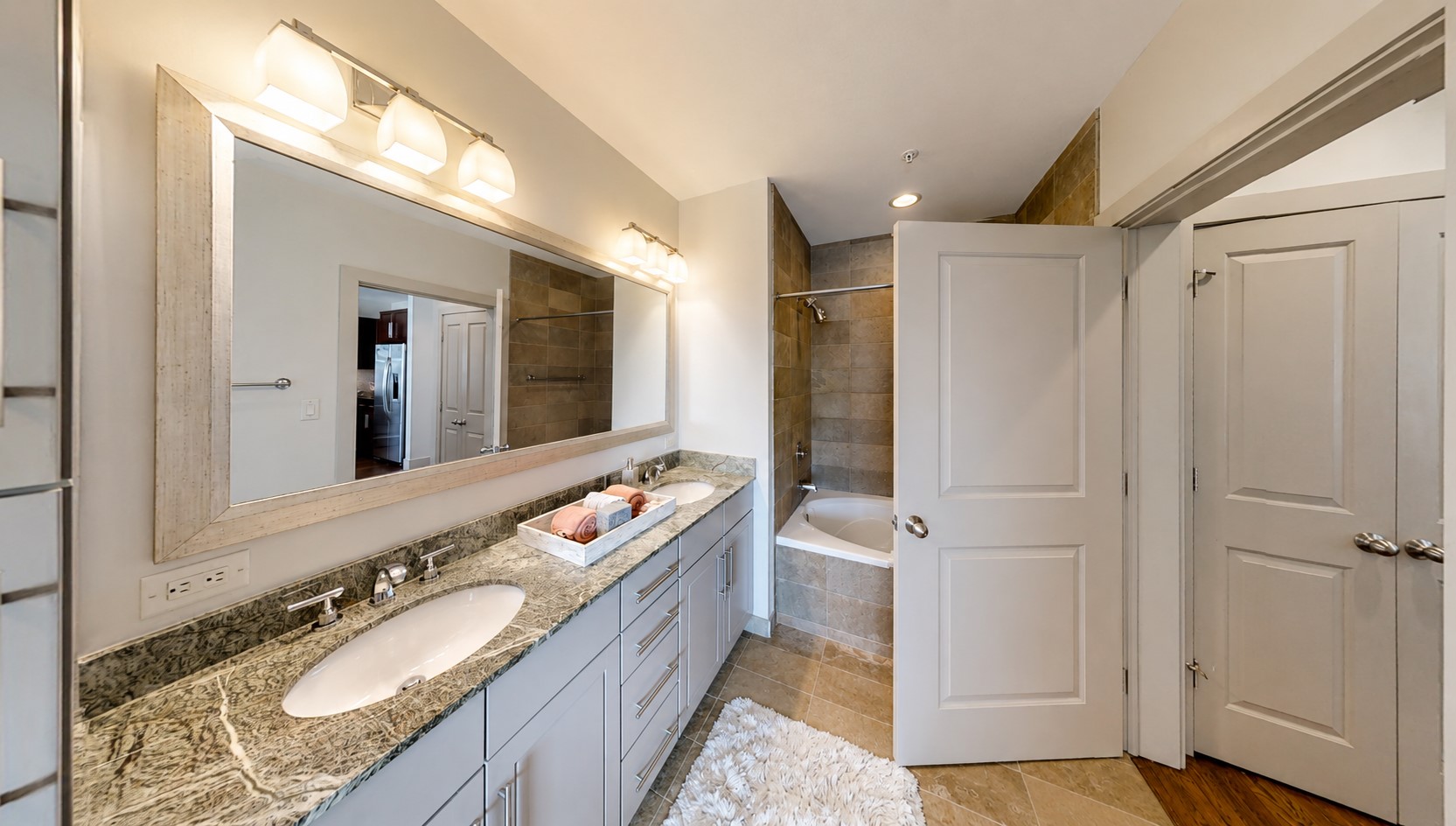 The primary bath gives you plenty of room to get ready comfortably, with dual sinks, generous counter space and a separate tub and shower.