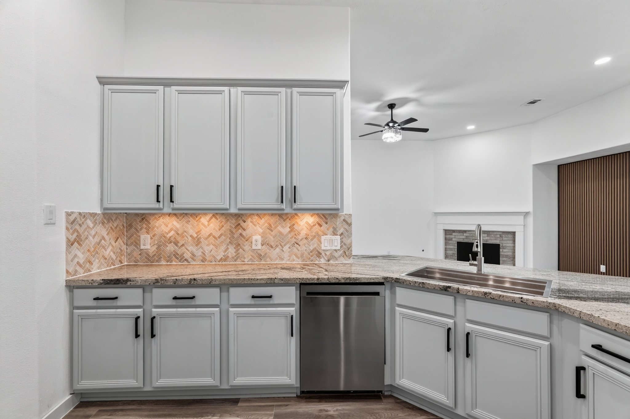 A closer look at the kitchen's showstopping modern  tile backsplash at 18 Griffin Hill Court  a bold design choice that adds personality and color to this gorgeous gourmet space. Paired with sleek grey cabinetry and light stone countertops, this eye-catching detail elevates the kitchen's contemporary design and makes a lasting impression.