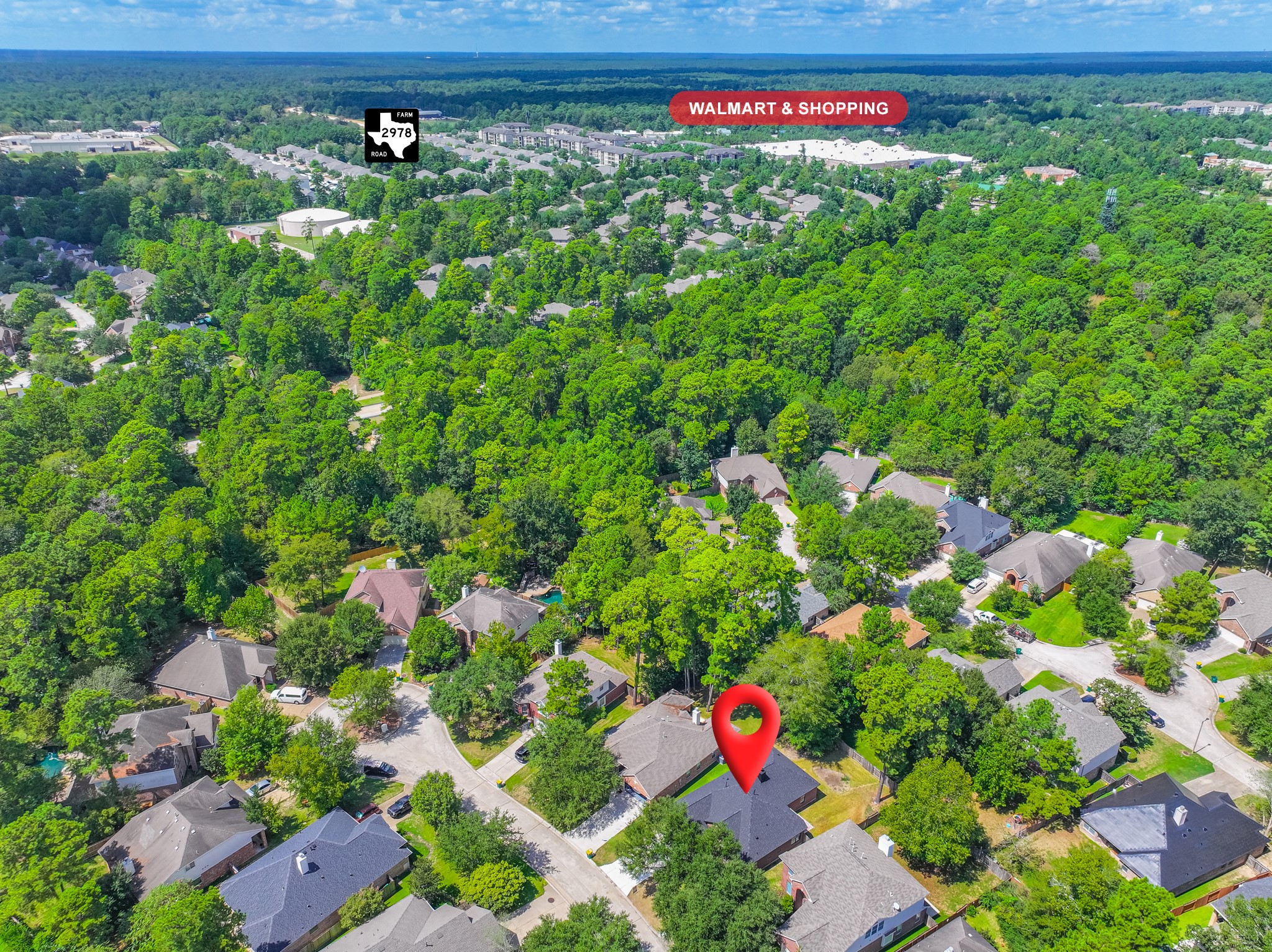 Higher aerial perspective showcasing 18 Griffin Hill Court and its surrounding community. The established neighborhood features mature tree canopies, well-maintained homes, and a peaceful residential setting. This bird's-eye view captures the wonderful sense of community and easy access to the Spring, Texas area's many sought-after amenities.