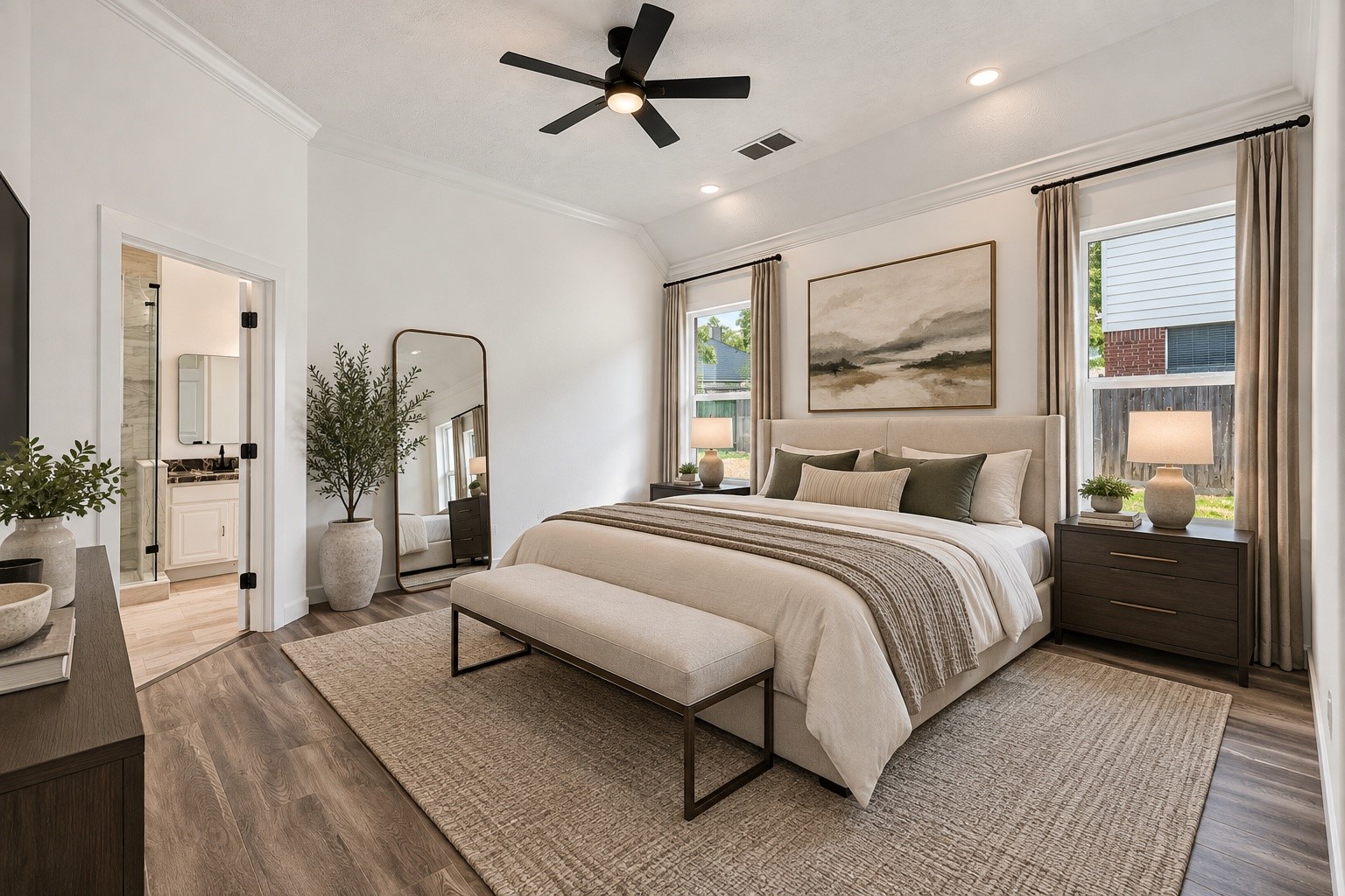 (VIRTUALLY STAGED PHOTO) The luxurious primary bedroom at 18 Griffin Hill Court is beautifully brought to life through virtual staging. A gorgeous king-sized bed with designer bedding, stylish bedside tables, and framed wall art demonstrate how perfectly the room's generous proportions, ceiling fan, and abundant natural light combine to create the ultimate personal retreat.