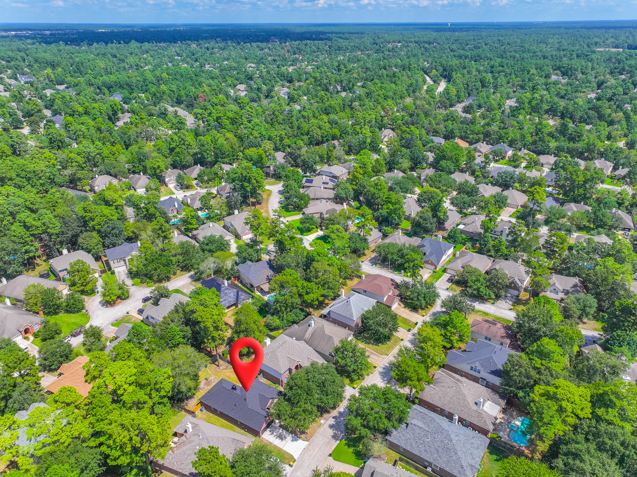 Aerial view highlighting the prime location of 18 Griffin Hill Court within its lushly canopied neighborhood. Towering mature trees create a stunning green landscape throughout this established community, offering privacy, shade, and the serene residential atmosphere that makes this Spring, Texas neighborhood so desirable to call home.