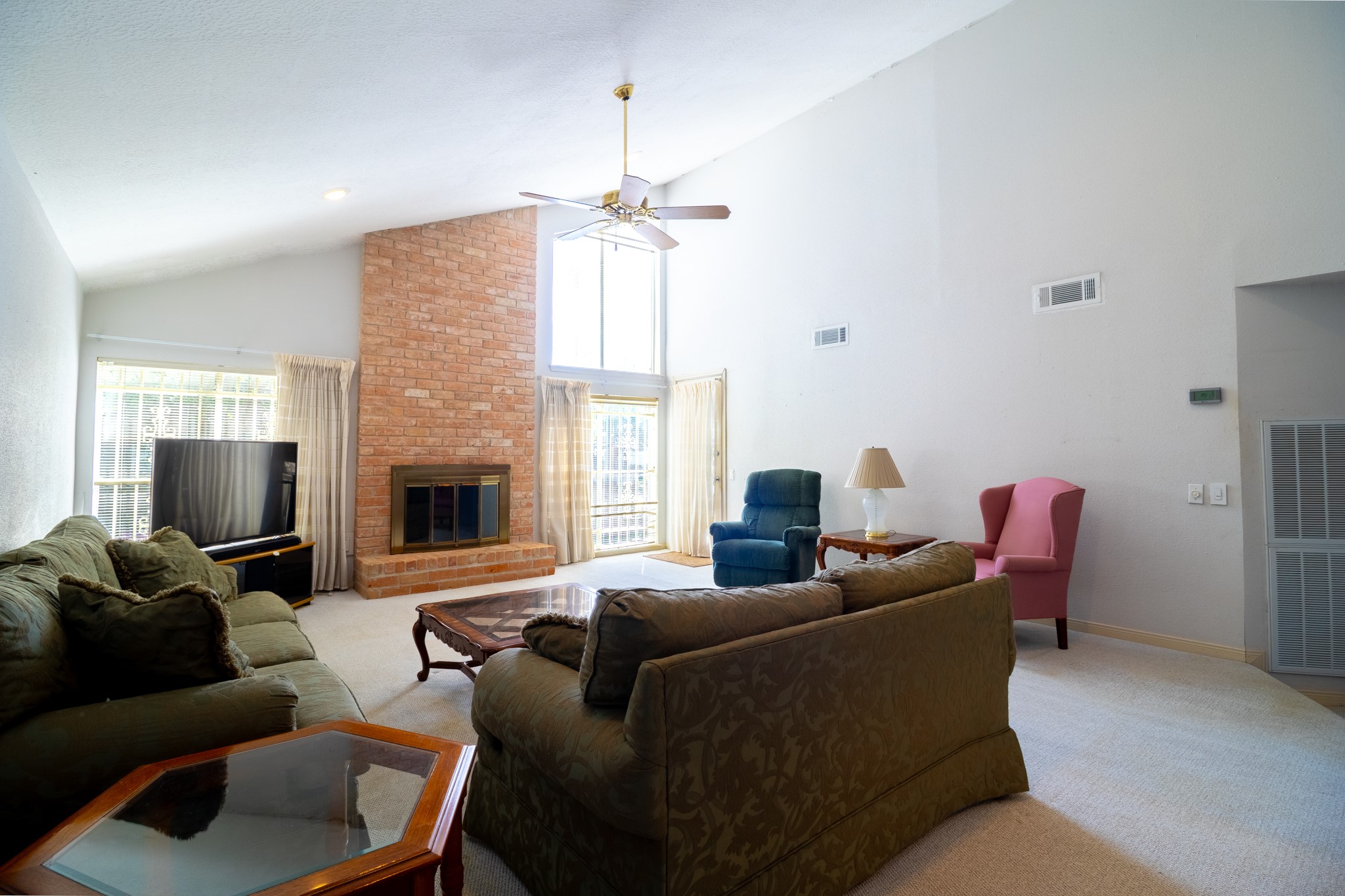 A fireplace, soaring ceilings, and room to gatherimagine the living room you could create in this space!