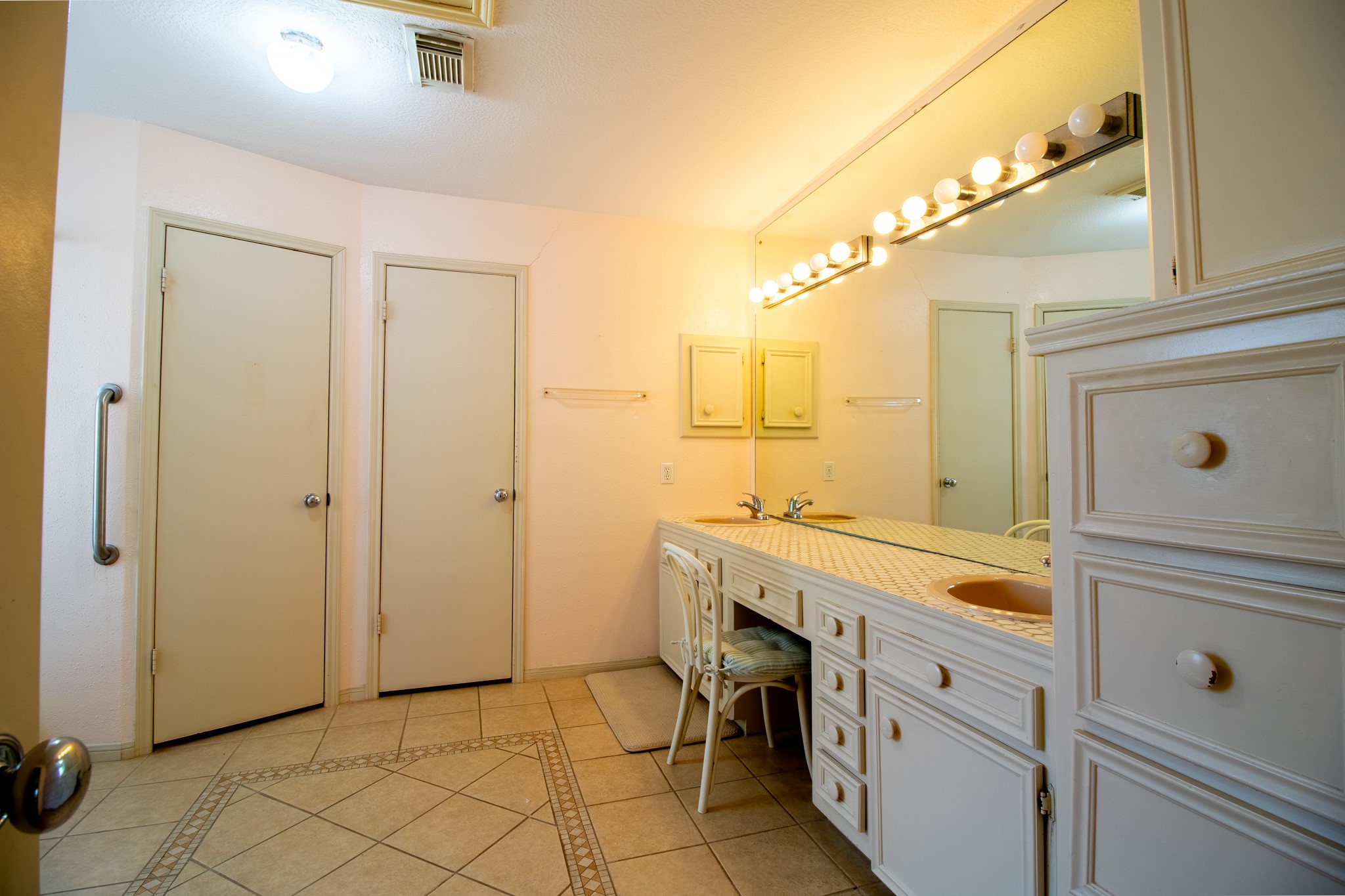 Dream of organizing everything just the way you like it with this bathroom's extensive cabinetry and counter space.
