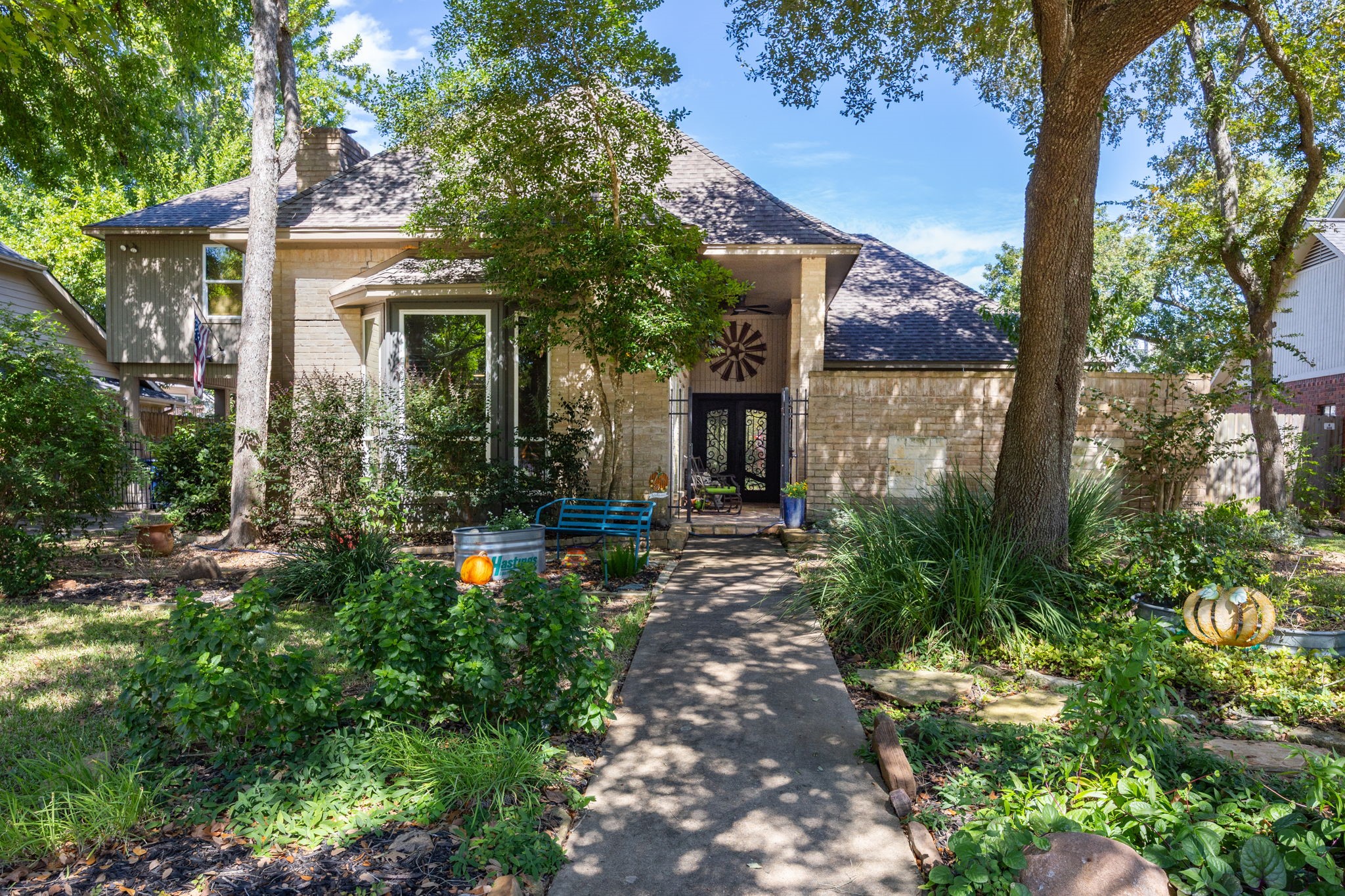 Welcome to 1622 Rambling Stone in Pecan Grove, where mature trees, lush landscaping, and a winding walkway introduce a home filled with character and distinctive architectural details.
