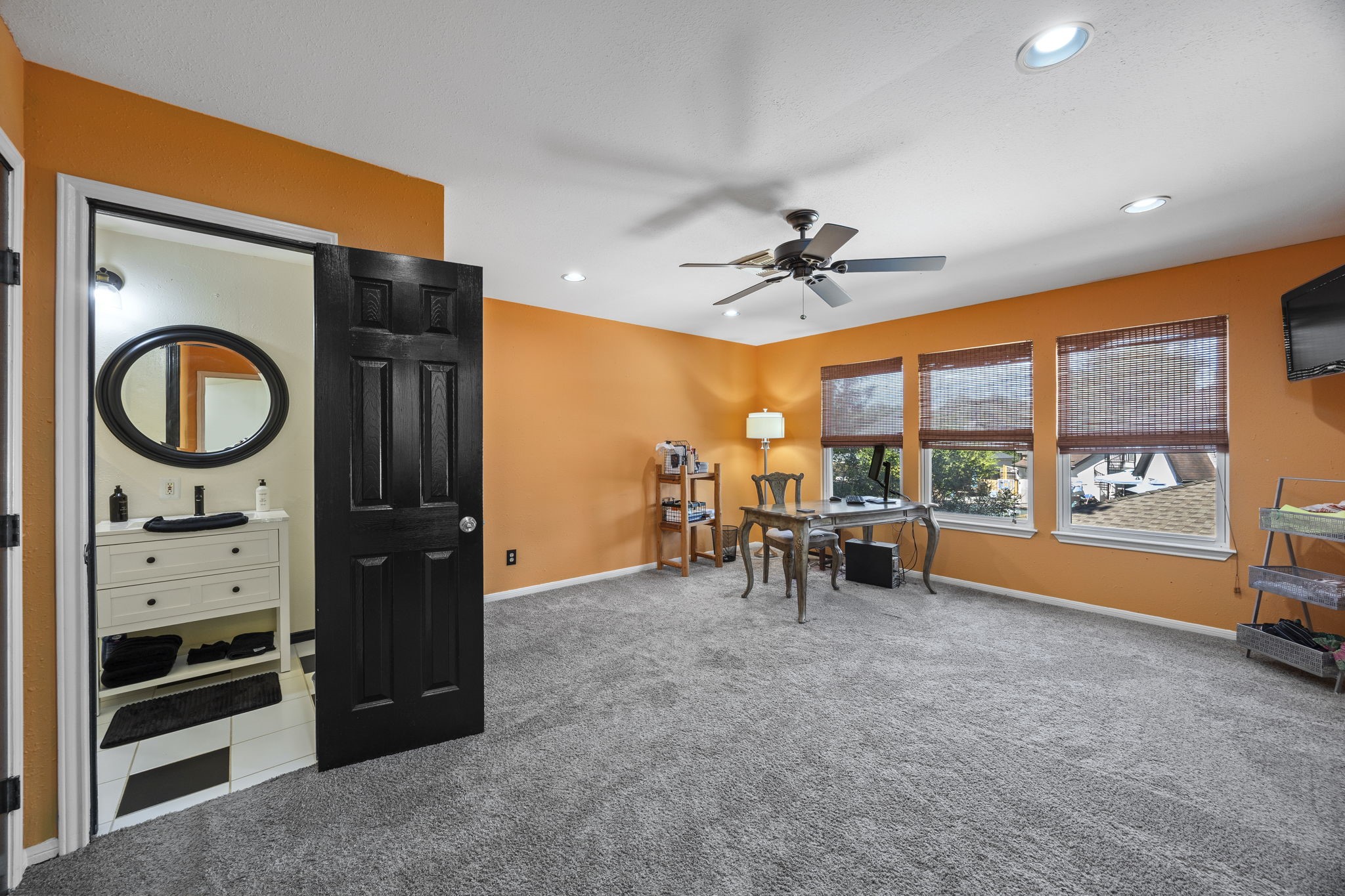 Generously sized third upstairs bedroom offers the flexibility of a second primary suite, complete with a private ensuite bathroom. Multiple windows, ample floor space, and room for a sitting area make this an excellent option for guests or multigenerational living.