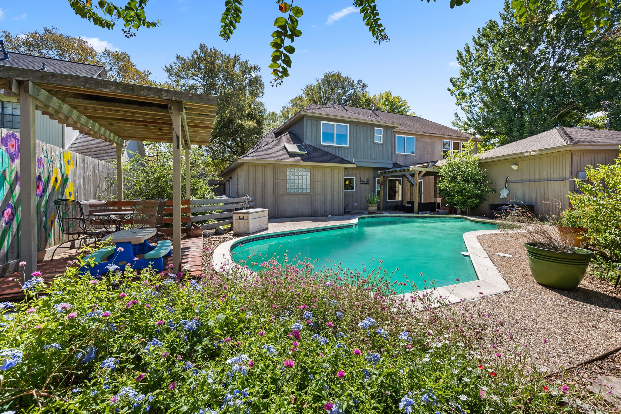 This is the backyard you have been waiting for! Lush landscaping, colorful blooms, a sparkling pool, and inviting outdoor living spaces come together to create a private retreat. A place to truly call home.