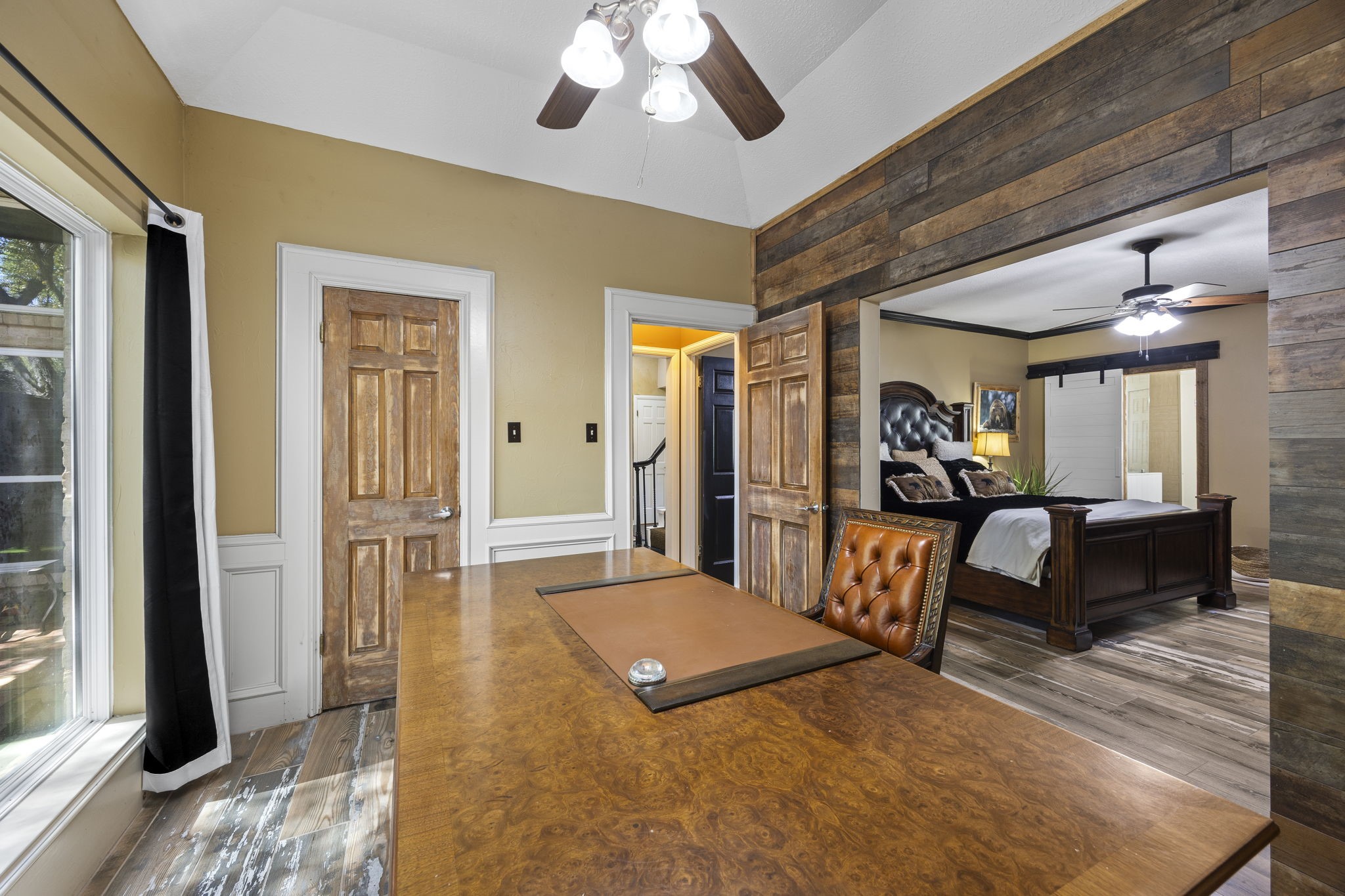 Conveniently located near the entry and connected to the primary bedroom, this versatile space offers numerous possibilities, including a home office, nursery, reading retreat, or private sitting room. The wood-accented wall adds warmth and character.