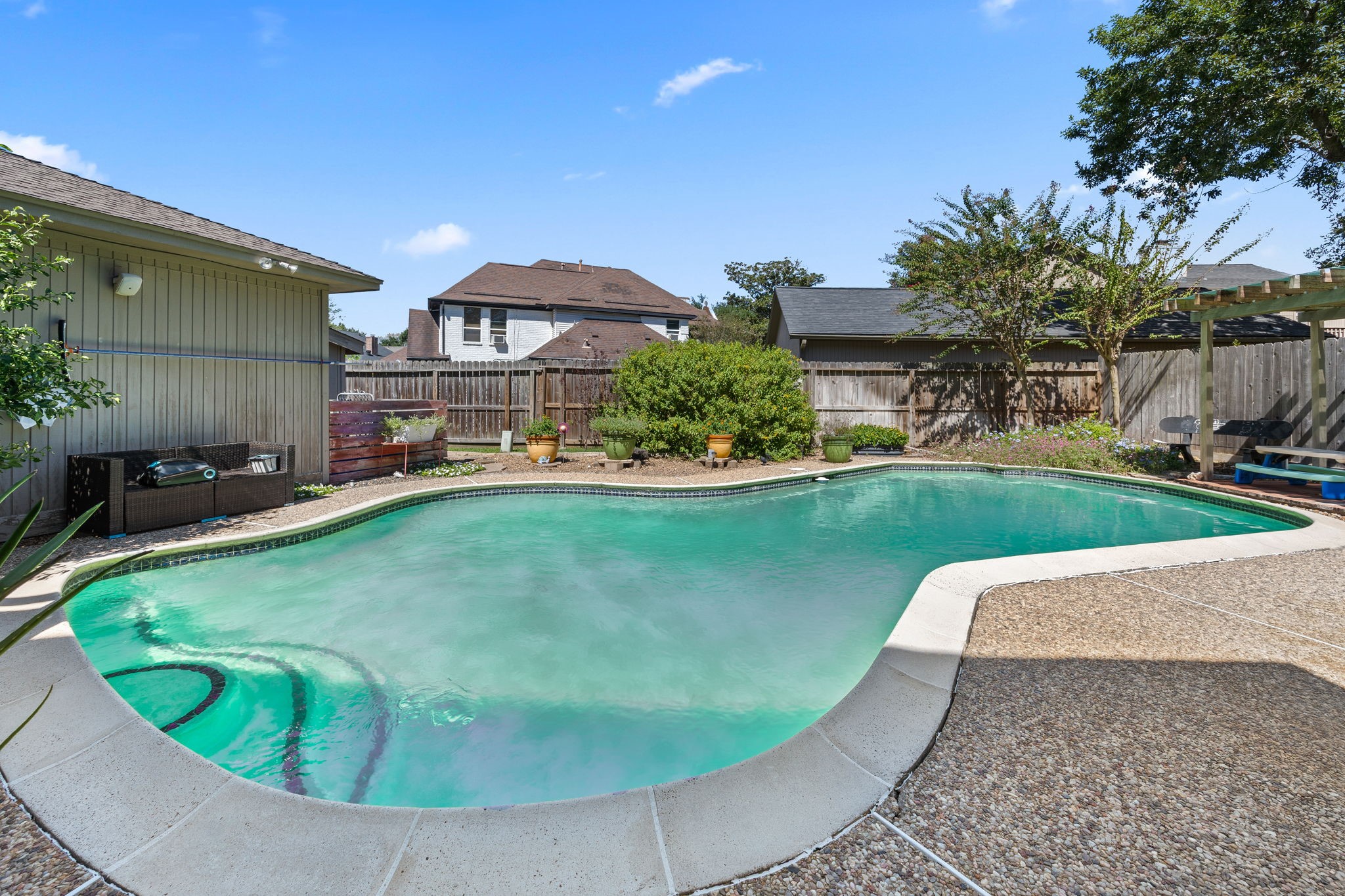 Enjoy your own backyard retreat with a generously sized swimming pool, expansive decking for lounging and entertaining, and surrounding landscaping. Plenty of room to enjoy sunny afternoons, weekend gatherings, or a relaxing swim at home.