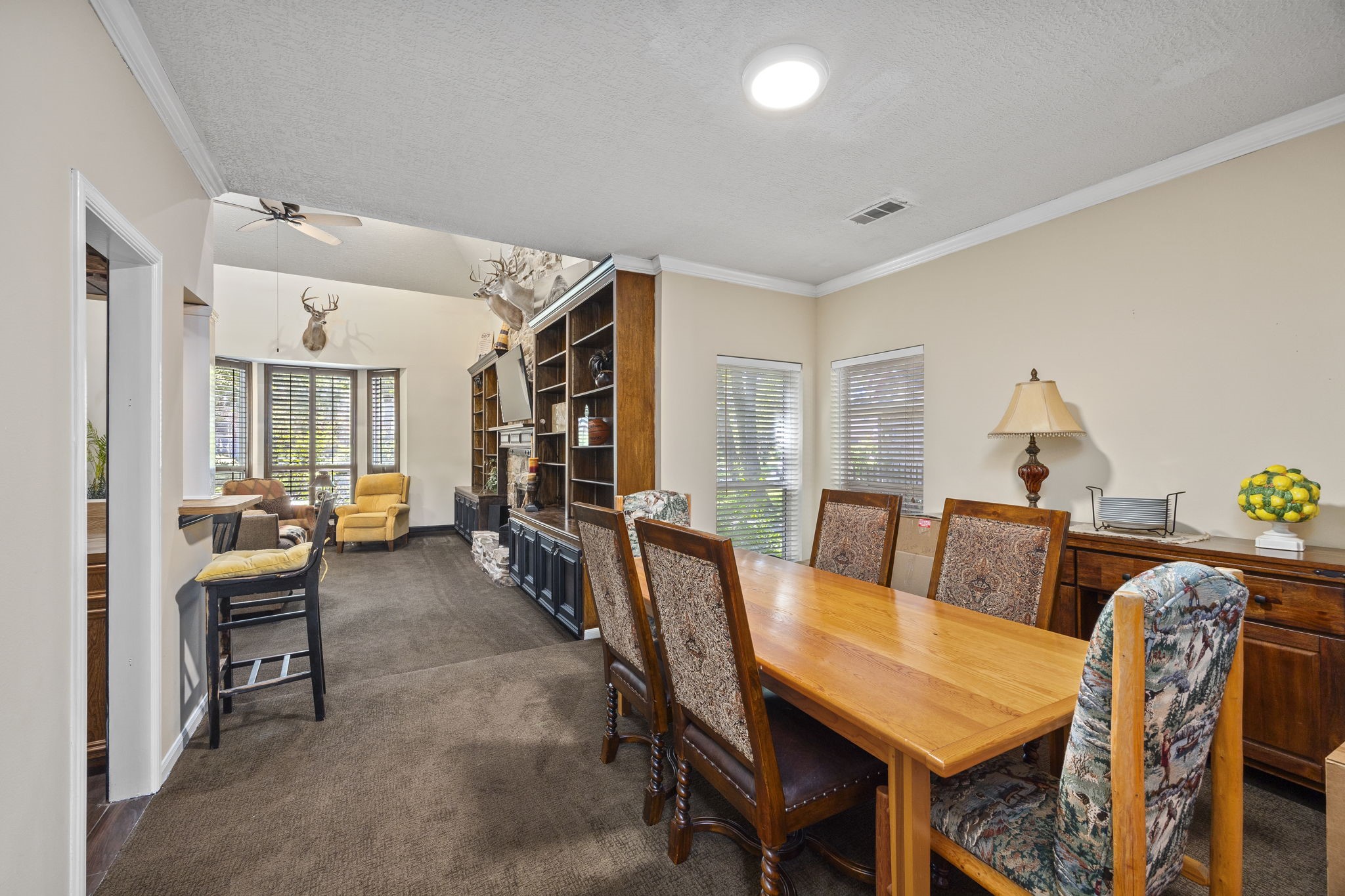 The formal dining room offers ample space for gatherings, with convenient access to both the kitchen and main living area. Its open connection to the living room allows for an easy flow when entertaining family and friends.