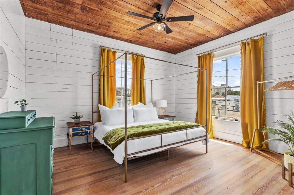 Bedroom one on the second floor. Hardwood Floors, stained ceiling and updated ceiling fan. Large windows letting in natural light