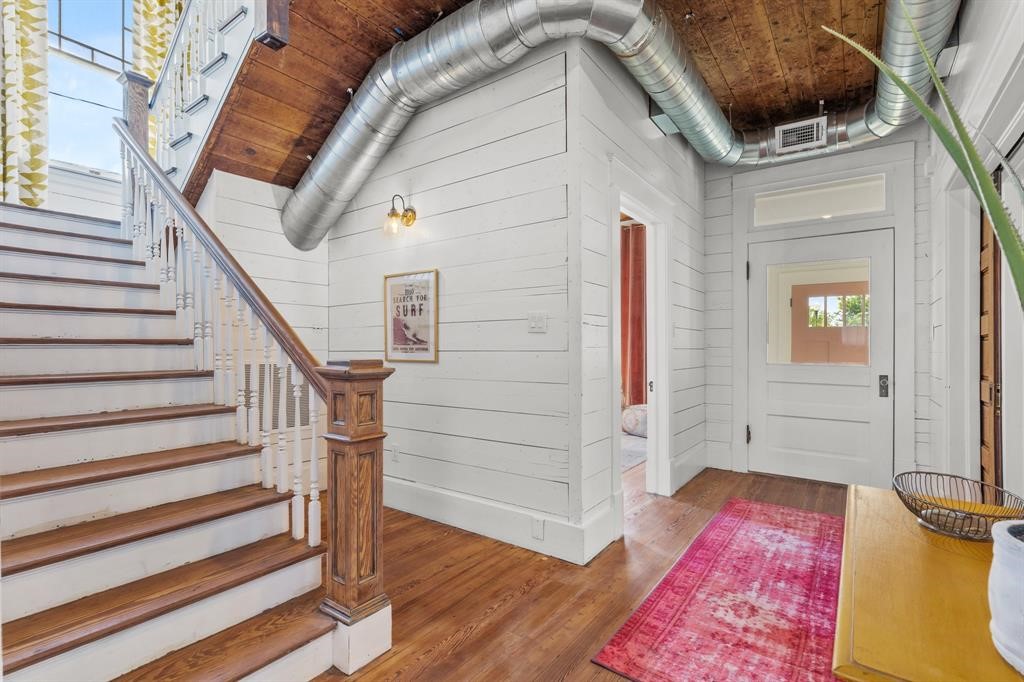 Stairs at the entryway featuring beautiful hardwood floors. Stairs at the entryway featuring beautiful hardwood floors.