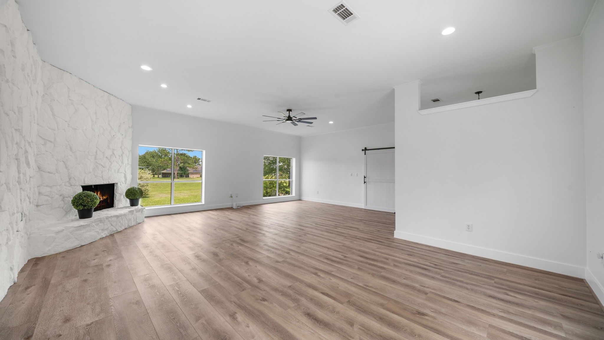 Family room with tall ceilings with custom wood burning fireplace