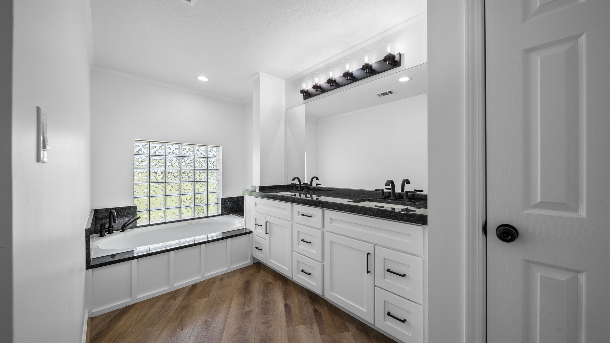 Primary bath with jetted tub, separate large shower and large linen closet.  So much storage  All new double sinks cabinets, fixtures and granite throughout
